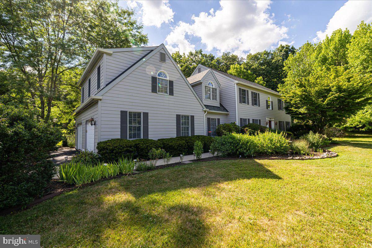 Welcome to this beautifully maintained Colonial in the highly desirable Hunters Crossing community, nestled on a private 2.33-acre lot within the award-winning Central Bucks School District. Offering 4 bedrooms, 3 full bathrooms, and exceptional indoor and outdoor living spaces, this move-in ready home combines privacy, comfort, and convenience.
A grand two-story foyer welcomes you inside, flanked by a formal dining room with elegant crown and chair rail molding and a spacious living room featuring glass French doors for added privacy. Rich hardwood flooring flows throughout the home, complemented by abundant natural light.
Just beyond the foyer, a private home office offers a custom-built desk situated with peaceful views of the backyard and pool, making it the perfect workspace. French doors separate the office from the breakfast area and kitchen, providing both privacy and functionality.
The expansive kitchen is designed for everyday living and entertaining, featuring abundant cabinetry, generous counter space, a center island with seating, and a convenient pass-through with bar-height seating overlooking the dramatic family room. The impressive family room showcases soaring vaulted ceilings, a floor-to-ceiling fireplace, and a Vermont Castings Defiant Encore wood stove that provides both warmth and charm.
Adjacent to the kitchen, the spacious mudroom includes the laundry area, a full bathroom with a stall shower, direct access to the attached two-car garage, and a rear entrance leading directly to the backyard and pool.
Upstairs, you'll find three generously sized secondary bedrooms, including walk-in closets, an office, and a full hall bathroom featuring a double vanity and tub/shower combination. Privately situated at the end of the hallway, the luxurious primary suite offers a separate sitting area ideal for reading, relaxing, or a workout space, along with an expansive bedroom, multiple walk-in closets, and an en-suite bath complete with a soaking tub, stall shower, and double vanity.
Step outside to your own private backyard retreat. Enjoy summer days on the deck beneath the retractable awning overlooking the sparkling saltwater pool and hot tub. The fenced backyard offers exceptional space for entertaining, enhanced by a beautiful stone wall and a variety of mature fruit trees lovingly planted and maintained by the current owner.
Ideally located just minutes from both Doylestown and New Hope, you'll enjoy easy access to charming boutiques, acclaimed restaurants, coffee shops, bookstores, museums, and year-round community events. Convenient proximity to major highways and New Jersey makes commuting to New Jersey, New York City, or Philadelphia a breeze.
Recent improvements include a new pool heater, conversion to a saltwater pool, pool coping, tile, and resurfacing (2019), Hardie Plank siding, roof (2014), new water filtration system, new oil tanks, whole-house generator, and the deck is scheduled to be freshly painted prior to closing.
This exceptional property offers the perfect blend of timeless elegance, modern updates, and a peaceful setting ready to be enjoyed by its next owners.