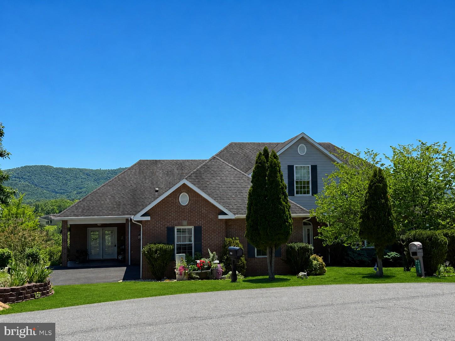 Tucked away at the end of a quiet cul-de-sac in one of Cumberland’s premier neighborhoods, 10002 Carrington Court offers luxury, comfort, and breathtaking mountain views in every direction — all with convenient access to I-68 and no city taxes! Ideally located just minutes from UPMC Western Maryland, Allegany College of Maryland, downtown Cumberland, shopping, restaurants, and more. This immaculate all-brick ranch home showcases quality craftsmanship and thoughtful upgrades throughout. Step inside through the elegant cut-glass entry door with sidelights into a welcoming foyer that opens to a spacious main level featuring vaulted ceilings, custom built-ins, rich oak trim, and solid oak doors. The inviting living room is anchored by a stunning double-sided propane fireplace shared with the formal dining room, creating the perfect setting for entertaining or relaxing evenings at home. The expansive kitchen is truly the heart of the home, complete with quality cabinetry, a center island, peninsula breakfast bar, pantry, breakfast area, and attached sunroom perfectly positioned to capture the spectacular mountain views. Just off the oversized two-car garage, you’ll find a huge laundry/mudroom with an attached half bath for added convenience. The spacious primary suite features tray ceilings, two walk-in closets, and a luxurious attached bath with a soaking tub and walk-in shower. Two additional generously sized bedrooms and a large hall bath complete the main level. The fully finished walk-out lower level offers exceptional additional living space, including a massive rec room with pellet stove, fourth bedroom, third full bath, media/theater room, pool table area, workshop space, and abundant storage. Walk directly out to the lower-level patio from either the rec room or bedroom and enjoy the privacy of the beautifully maintained yard. Additional highlights include an enormous attic, heat pump with central air, outstanding curb appeal, and meticulous pride of ownership throughout. This is a rare opportunity to own a truly exceptional home in one of Cumberland’s most desirable locations.