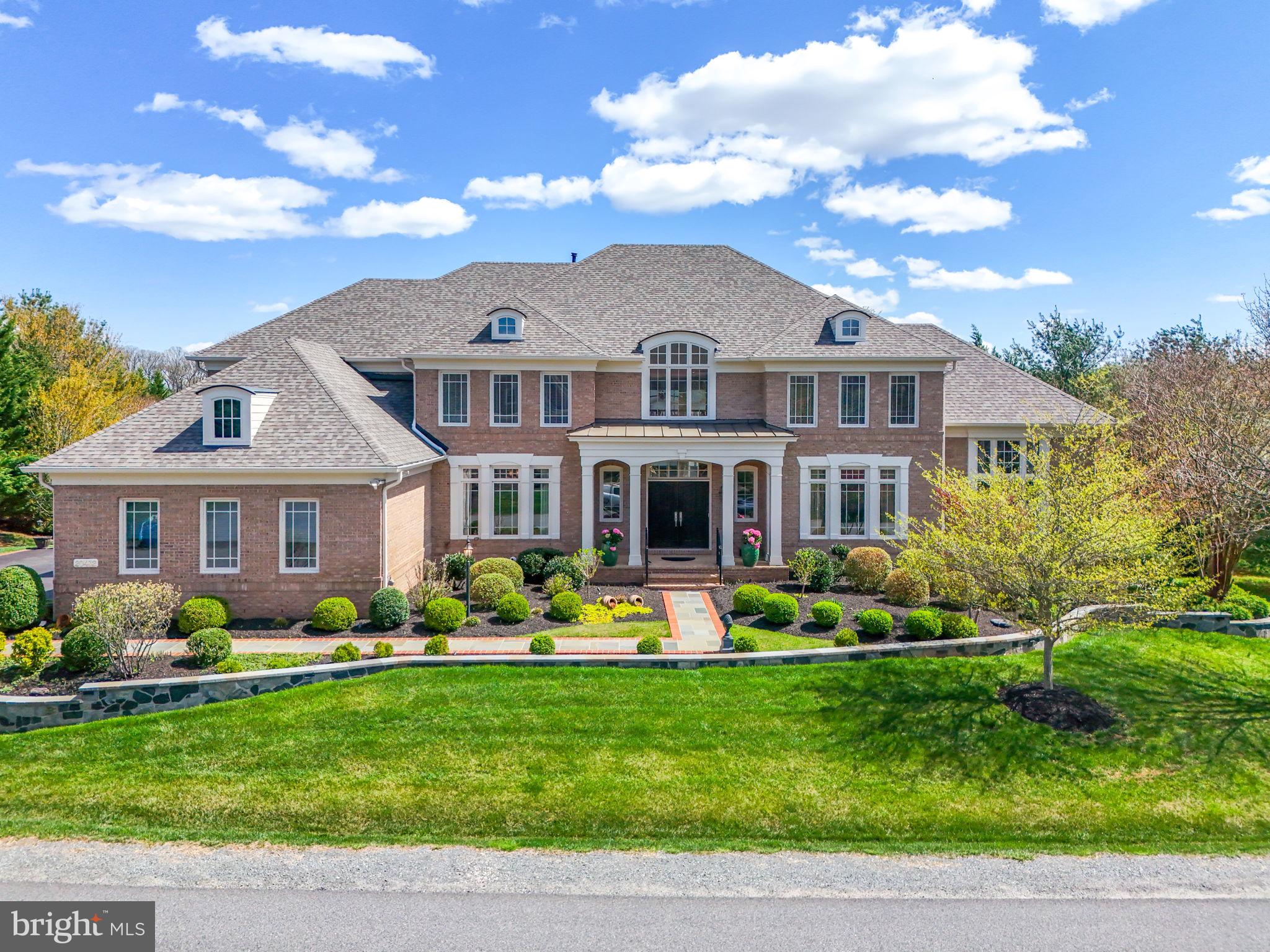 EXQUISITE LUXURY ESTATE IN RED CEDAR WEST -- Discover refined elegance in this meticulously updated Gulick Homes Winthrop model nestled on 1.12 fully irrigated private acres in prestigious Red Cedar West. This stunning residence offers nearly 8,000 square feet of luxurious living space, completely renovated throughout 2023-2024 with over $300,000 in premium upgrades. DISTINCTIVE FEATURES: 7,973 SF of total finished living space (5,400 SF above grade, 2,573 SF finished basement; 5 bedrooms, 5 full bathrooms across three thoughtfully designed levels; Gourmet chef's kitchen featuring SubZero refrigerator, Wolf range, custom Amish cabinetry; Two-story foyer with striking curved staircase setting an impressive tone upon entry; Home office with ensuite bath offering flexibility as a main-level bedroom suite; Full theater room with premium seating (conveys with home); Built-in wine cellar for the discerning collector; Four-zone HVAC system for optimal comfort throughout; Professional-grade outdoor kitchen with pizza oven and fireplace; 856 SF elevated deck overlooking the private, tree-lined property; Professional landscaping with stone wall and built-in landscape lighting; Spacious 3-car garage with ample storage options; Room for additional 2-car garage and in-ground pool. RECENT LUXURY UPGRADES (2022-2024): New roof installation (2023); Complete reconstruction and painting of all windows; Exterior facade enhancement with professional landscaping; Full renovation of master bathroom and two additional bathrooms; Gourmet kitchen redesign with premium appliances and finishes; Refinished hardwood flooring throughout all levels; Fresh interior paint throughout entire home; New HVAC systems (main and upper levels); New water heater installation (2024); Updated window treatments throughout. MAIN LEVEL: Grand two-story foyer with curved staircase, dedicated office/optional bedroom with ensuite bath, formal dining room, conservatory, chef's kitchen open to spacious family room, and sun-drenched sunroom overlooking the private backyard. UPPER LEVEL: Luxurious owner's suite with completely renovated spa bathroom, three additional bedrooms, and two newly updated full bathrooms. LOWER LEVEL: Resort-style entertainment space featuring full wet bar, recreation area, family room, professional theater, exercise room, wine cellar, additional bedroom and full bathroom, plus walkout access to the backyard oasis. Includes 673 SF of unfinished storage space. OUTDOOR LIVING: Over 1,500 SF of finished outdoor space. Entertain in style on the expansive 856 SF deck or gather around the outdoor kitchen and fireplace on the newly extended patio. The 1.12-acre property features mature trees creating a natural privacy barrier while maintaining an open, manicured lawn perfect for outdoor enjoyment. LOCATION: Situated in the prestigious Red Cedar West neighborhood in Leesburg, this home offers privacy and tranquility while remaining convenient to the area's finest shopping, dining, and major commuter routes. This meticulously maintained and updated luxury estate represents an exceptional opportunity to acquire one of Leesburg's premier residences.
