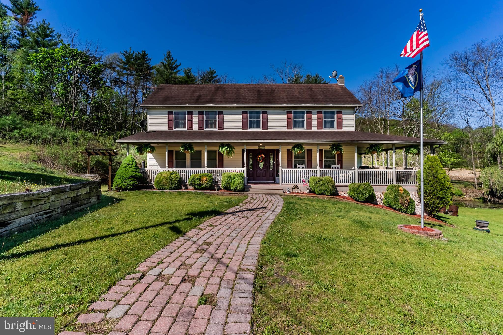 Nestled on 35 peaceful acres in Juniata County, this stunning 5-bedroom, 3-full-bath home offers the perfect escape from the hustle and bustle, blending privacy, comfort, and charm with exceptional space inside and out. Relax and take in the beauty of the surrounding countryside from the expansive wraparound porch, or step inside to a welcoming foyer highlighted by a full wall of custom built-in bookcases. The main level features a spacious primary suite with a walk-in closet, private bath, and convenient first-floor laundry. The thoughtfully designed large dining room has custom painted ceiling and a very large storage closet. The heart of the home is the well-appointed kitchen, offering abundant storage, a center island, stainless steel appliances, propane stove, double electric oven, and direct porch access, perfect for entertaining or enjoying your morning coffee outdoors. The large living room is filled with natural light and showcases vaulted ceilings, a cozy fireplace, and access to a private deck, creating a warm and inviting atmosphere. Upstairs, you’ll find two oversized bedrooms, each with walk-in closets, along with a full bath featuring laundry hookups for added convenience. The partially finished walk-out basement expands your living space with two additional bedrooms, a full bath, a craft room, and plenty of storage. Outside, the property is equally impressive with a barn, two-story 3-car garage with electric, garden shed, additional large storage shed, and a tranquil pond—ideal for hobby farming, recreation, or simply enjoying nature’s beauty. If you’ve been dreaming of a peaceful country retreat with room to live, work, and unwind, this extraordinary property delivers it all.