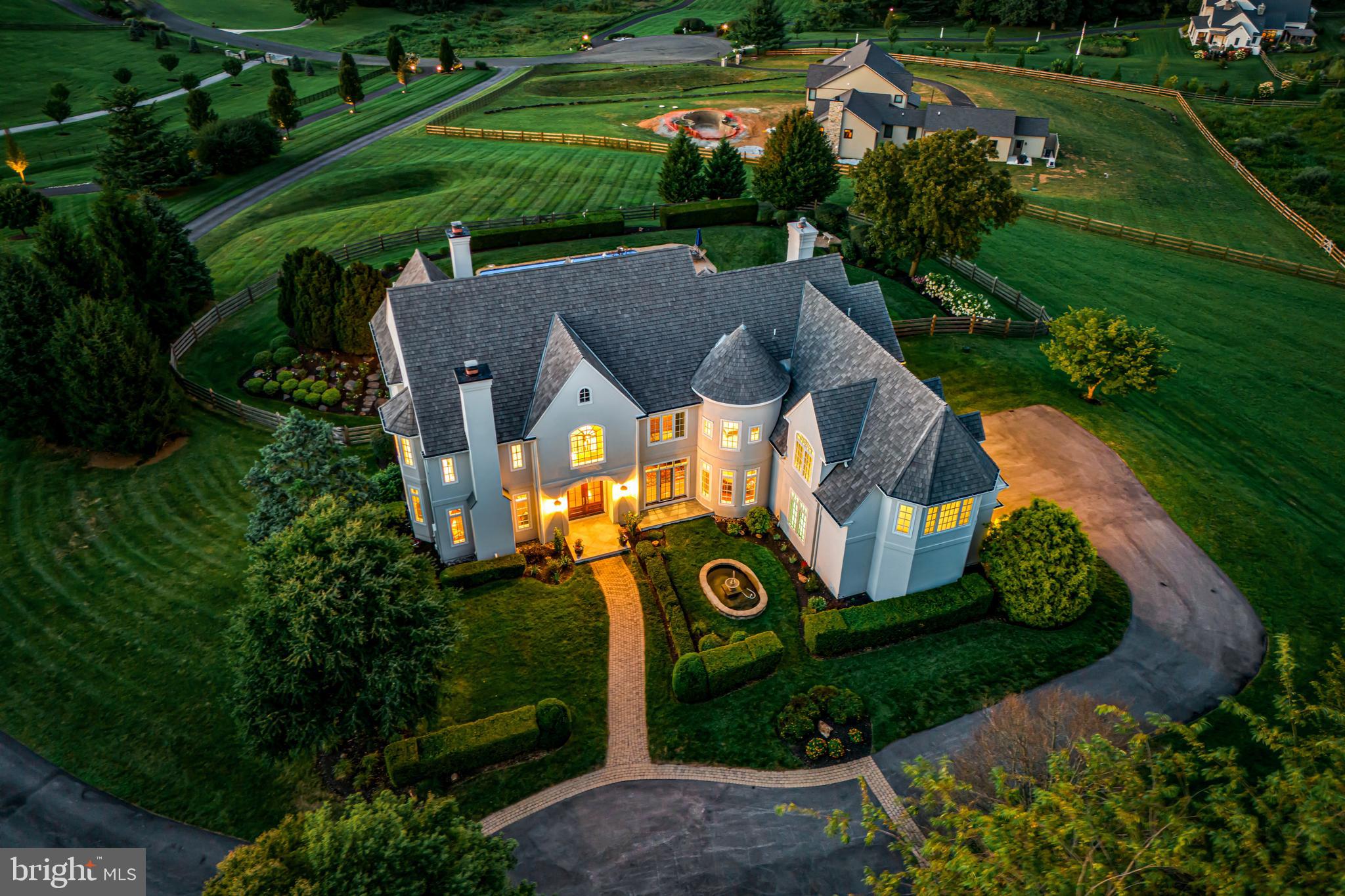 Simply spectacular in every way!!! This incredible better than new, custom-built, sun-filled residence was beautifully designed by Peter Batchelor, meticulously crafted by Dan Stoudt and is set on a beautiful 4-acre lot with pool and breathtaking views of the countryside and unparalleled sunsets. Fabulous first floor features include a stunning 2-story entrance foyer with curved staircase, opening up to the surrounding living room with gas fireplace, dining room with windowed piano space, expansive gourmet kitchen with artesian cabinets, granite countertops, Thermador, SubZero, Miele appliances and wet bar/ butler's pantry surrounding the large working/ eat-in island, adjacent breakfast room with windows and French doors looking out over the vast terraces, pool and grounds, inviting family room with media built-ins and cozy fireplace, private office, screened-in porch and convenient mudroom with powder room, rear staircase and access to the oversized 3-car garage. The spacious second floor offers a luxurious primary suite with sitting room, gas fireplace, his and hers baths renovated in 2023, walk-in closets, 2 additional large hall bedrooms each with a custom-tiled en-suite bathroom, and an expansive 4th bedroom/ in-law suite with custom marble bathroom featuring a soaking tub and frameless glass shower. The full, dry walk-out lower level is ready to finish with high ceilings, abundant space for multiple rooms, endless storage and easy access to the pool area, terraces and outdoor living spaces. An extensive list of the recent improvements/ renovations is available and includes a 40-year cedar shake roof , lighting, new systems, appliances, generator, primary bathroom and Florida room renovations and complete stucco remediation/ replacement in 2023. Move right in and enjoy all that this incredible Chester County property has to offer, close to renowned schools, endless recreational, dining and shopping opportunities, world class golf and equestrian facilities and more!