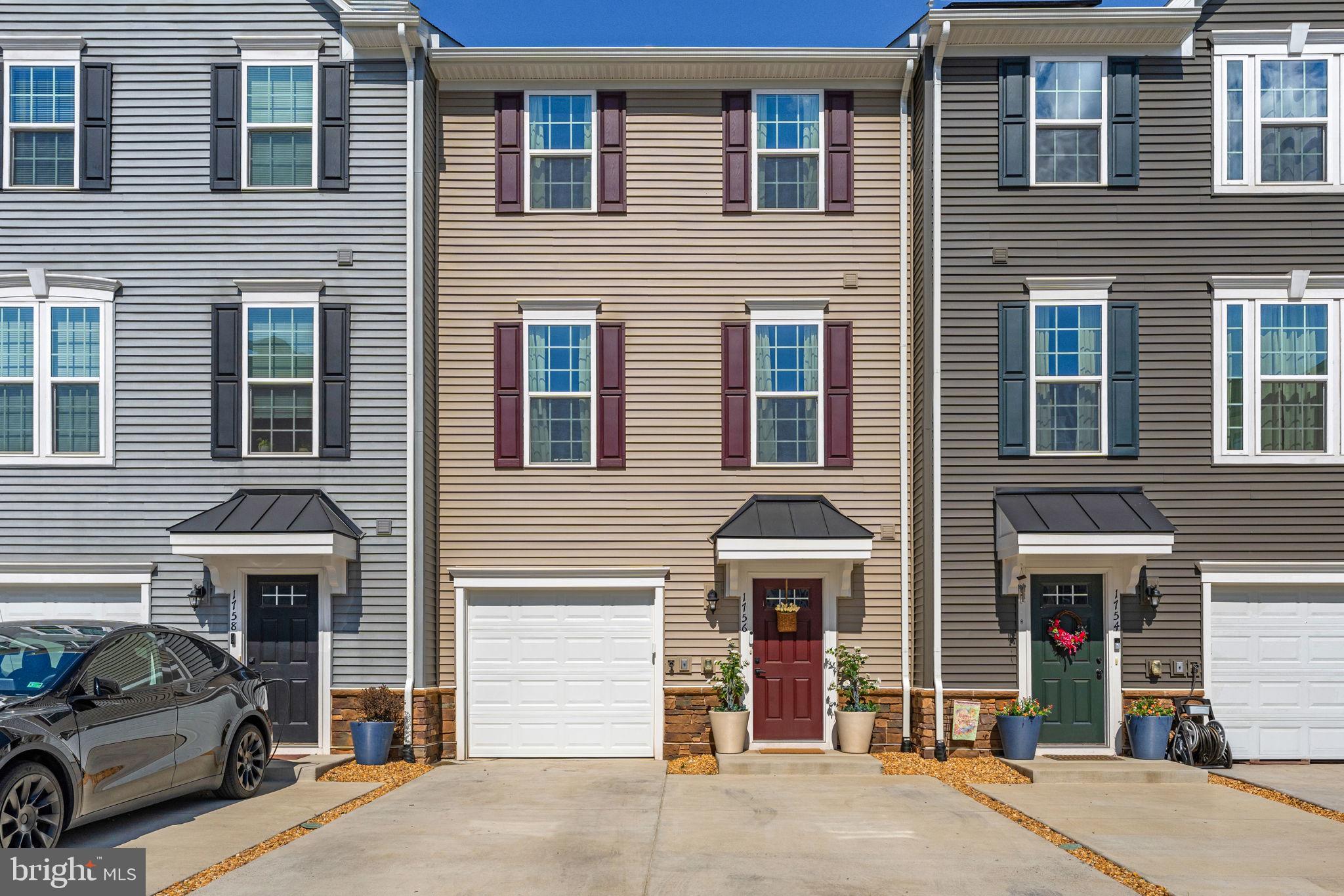 Welcome to 1756 Scenic Loop, a beautifully upgraded, like-new townhome in Culpeper's Madison Station. The lower level of the home features LVP flooring throughout, a half bath, a bright rec or flex space, and access to the attached one-car garage.  The main level offers an open and inviting layout with LVP flooring throughout, a spacious living room with an electric fireplace, and a stylish eat-in kitchen, featuring a large island, quartz countertops, and stainless steel appliances. Just off the kitchen, step onto the Trex deck and take in seasonal mountain views.  Upstairs, the owner’s suite includes mountain views, a tray ceiling, walk-in closet, and an upgraded en suite bath with a double vanity and shower bench. Two additional spacious bedrooms, a full bathroom, and a convenient laundry closet complete the upper level. Madison Station residents enjoy access to a community pavilion and a prime location less than a mile from historic downtown Culpeper, with quick access to Route 29 for commuters. This is a fantastic opportunity to own a nearly new home in a highly convenient location.