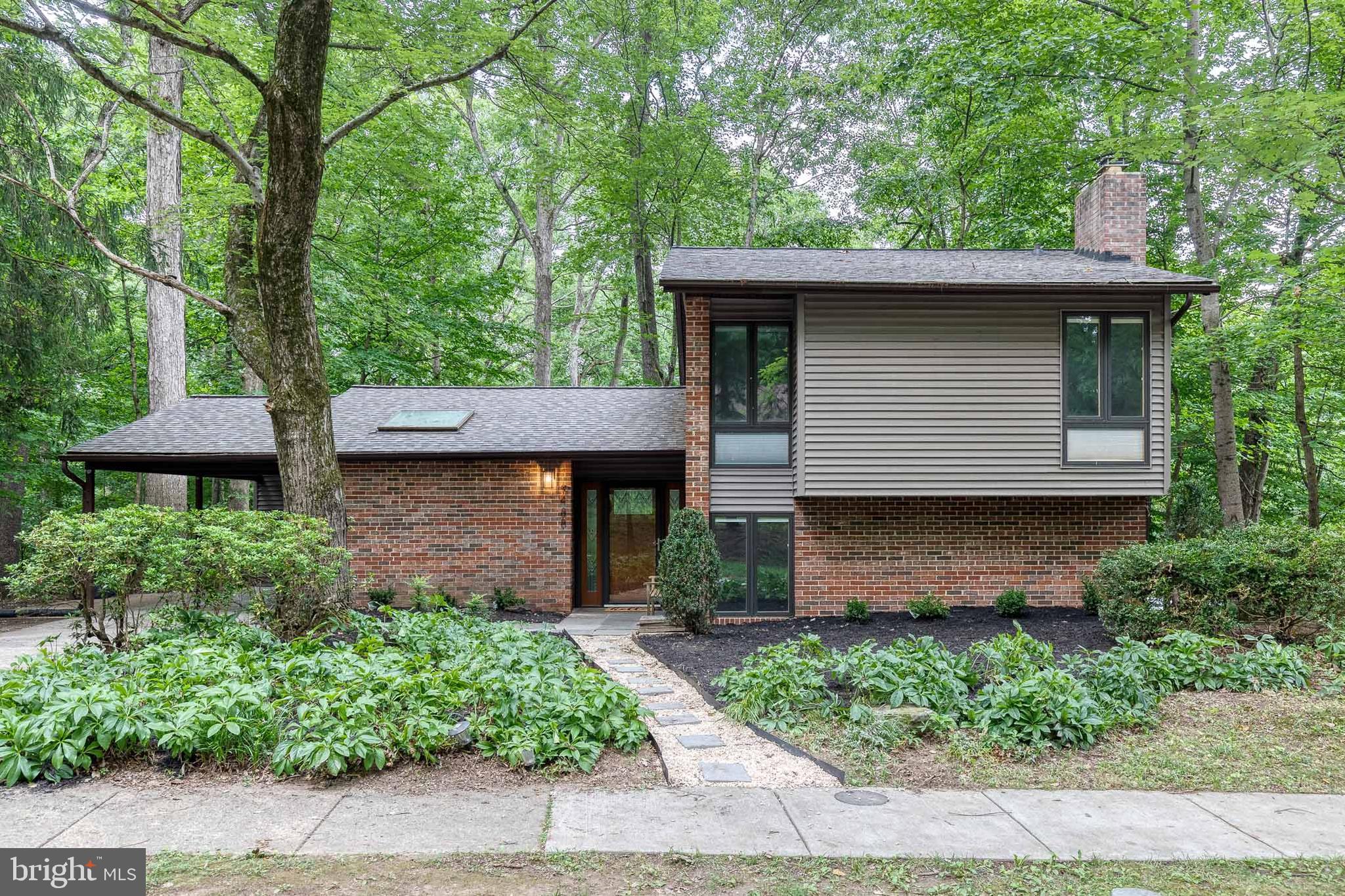 Welcome to this beautifully renovated split-level home nestled in the desirable Stevens Forest community of Columbia. From the moment you step inside, you'll appreciate the fresh, modern feel with new luxury vinyl plank flooring flowing throughout the home. The main level offers an open and inviting layout, featuring a spacious living room, dining area, and a stunning kitchen designed for both everyday living and entertaining. The kitchen boasts abundant cabinetry, generous prep space, quartz countertops, stainless steel appliances, a custom tile backsplash, and a convenient breakfast bar perfect for casual meals. Upstairs, retreat to the expansive primary suite filled with natural light, complete with a large closet and a beautifully updated en-suite bath featuring a custom tiled walk-in shower. Two additional generously sized bedrooms and a renovated full bathroom with a tiled tub/shower combination complete the upper level. The lower level provides the perfect place to unwind, offering a spacious recreation room centered around a charming brick gas fireplace. This level also includes a fourth bedroom, an updated full bathroom, and ample storage space, making it ideal for guests, a home office, or multi-generational living. Step outside to enjoy the rear deck, the perfect setting for summer barbecues, outdoor dining, and entertaining family and friends. Parking is effortless with a private driveway, covered carport, and an attached storage shed for all your outdoor equipment. Major updates provide peace of mind and modern style, including a new roof, all new luxury vinyl plank flooring, a fully renovated kitchen, and beautifully remodeled bathrooms. Conveniently located in Columbia's sought-after Stevens Forest neighborhood, you'll enjoy easy access to parks, walking paths, shopping, dining, commuter routes, and all of the amenities that make Columbia one of Maryland's most desirable places to call home. This move-in ready home is the perfect combination of modern updates, flexible living space, and an unbeatable location.