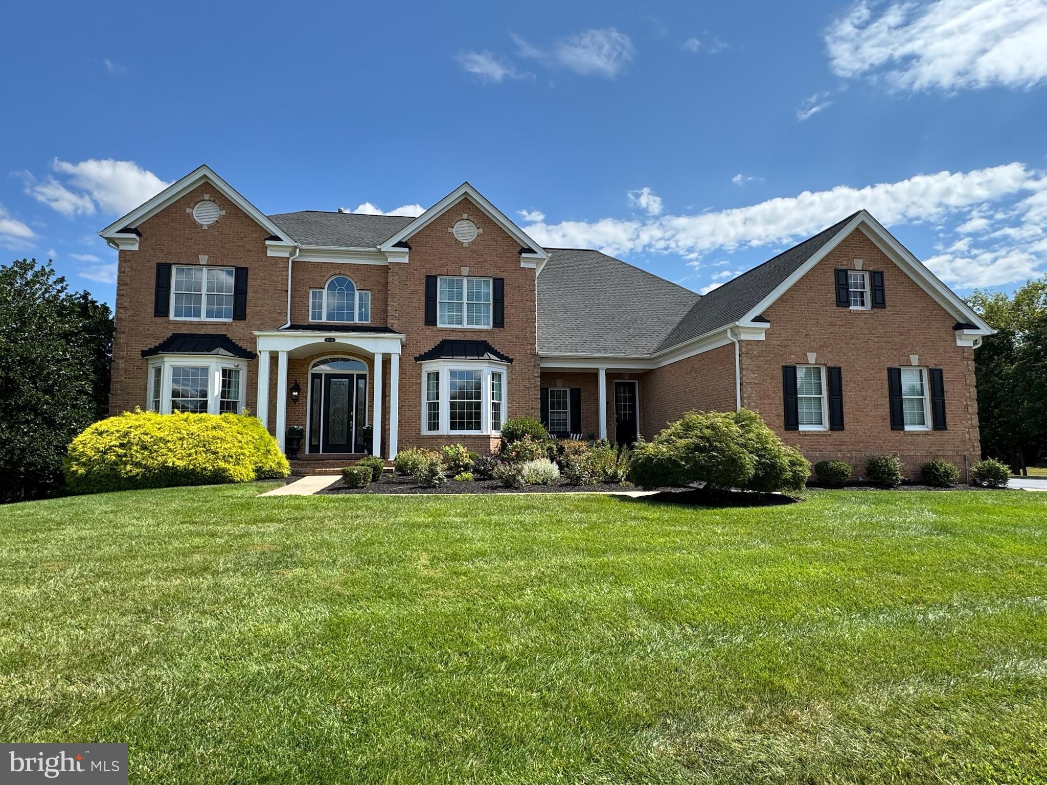 Nestled in the prestigious Loudoun Valley Estates, this exquisite Colonial-style residence offers a harmonious blend of luxury and comfort, perfect for those seeking an elevated lifestyle. This meticulously maintained home boasts a stunning brick front and vinyl siding, exuding timeless elegance. Step inside to discover a world of sophistication. The grand foyer welcomes you with a curved staircase, leading to a thoughtfully designed floor plan that seamlessly integrates living spaces. Rich wood floors and crown moldings enhance the warmth of the interiors, while chair railings add a touch of classic charm. The gourmet kitchen is a culinary enthusiast's dream, featuring upgraded countertops, a spacious island, and a butler's pantry that makes entertaining a delight. With energy-efficient appliances, including a double wall oven and warming drawer this kitchen is as functional as it is beautiful.  Adjacent entrance and laundry room features front-loading washer and dryer. The inviting dining area is perfect for hosting gatherings, while the cozy family room, complete with fireplace, creates an intimate atmosphere for relaxation. The home also features a wet/dry bar, ideal for crafting your favorite cocktails or enjoying a quiet evening in. Retreat to the luxurious primary bath, designed for ultimate relaxation, and enjoy the convenience of additional bedrooms and bathrooms that can be tailored to your needs. The fully finished basement, with a walkout level, gas fireplace and ample windows, fitness room and a separate temperature controlled wine room, provides endless possibilities for recreation or relaxation. Outside, the property is a true oasis. Spanning nearly an acre, the beautifully landscaped lot offers a serene escape from the hustle and bustle of daily life. The screened deck invites you to unwind while enjoying the tranquil surroundings, and the underground lawn sprinkler system ensures your outdoor space remains lush and vibrant. With a side-entry, three-car garage equipped with a garage door openers, parking is both convenient and stylish. The home is also equipped with a comprehensive security system, providing peace of mind. This residence is not just a home; it's a lifestyle. Experience the perfect blend of luxury, comfort, and elegance in this exceptional property, where every detail has been thoughtfully curated to create a warm and inviting atmosphere. Embrace the opportunity to make this stunning residence your own.
