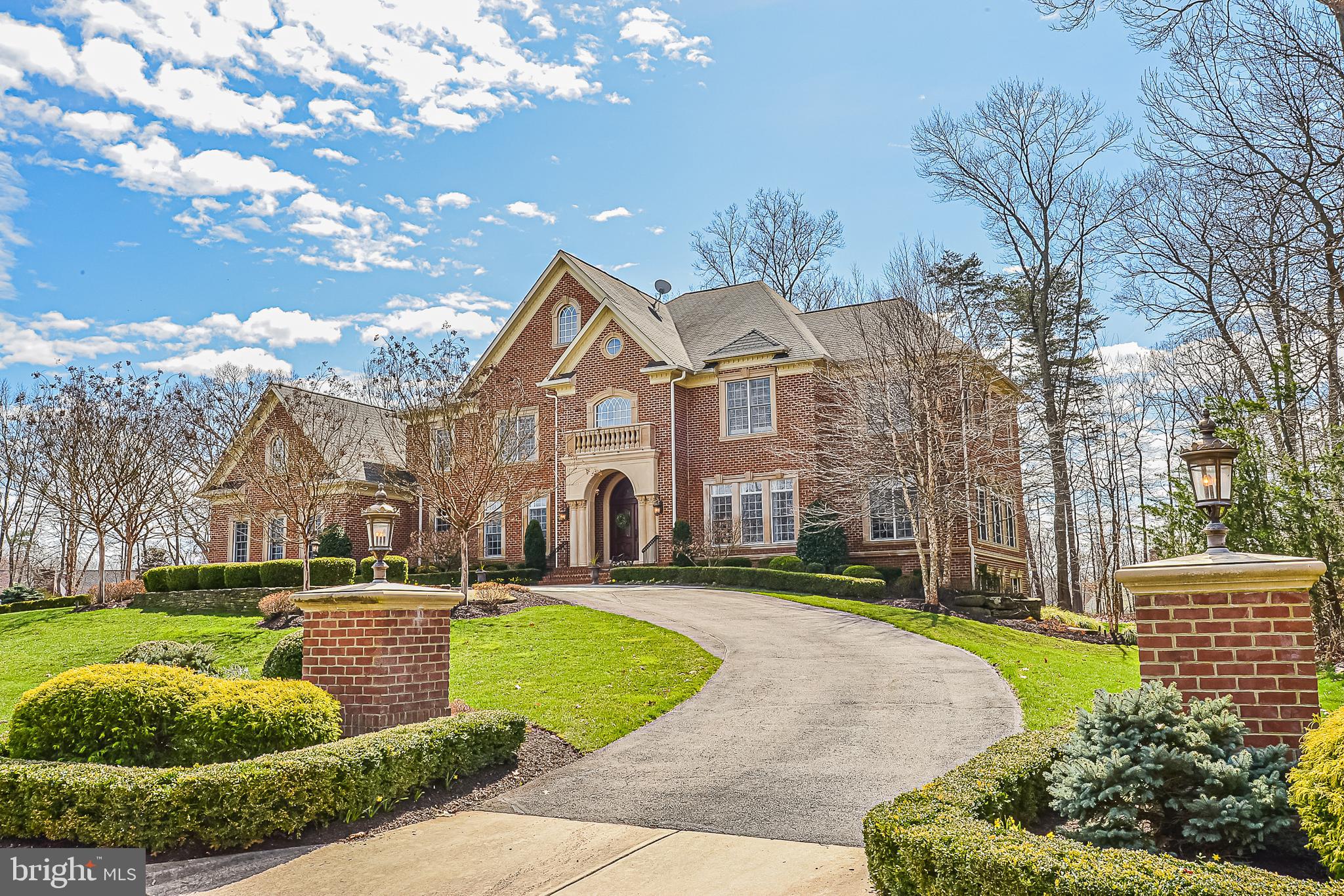 Oakton's Best Buy! Couldn't build today for under $5million. Warm & Welcoming Home with a Masterful Design, Quality Features and Exquisite Details throughout.  This impressive, meticulously maintained 5+bedroom, 7full/2half baths, all brick home has over 12,000sq.ft. of gracious living.  Situated on 1.74 acres at the end of a private cul-de-sac, the circular drive creates a nice sense of arrival.  Elegant marble floors greet you in the grand foyer, where you will immediately begin to appreciate all the gorgeous architectural details, including a dramatic stairway with ornate oak & wrought iron railings, magnificent coffered/vaulted/tray ceilings, archways, columns, decorative moldings and stunning light fixtures. Plenty of natural light flows throughout the home's open, airy layout. A formal Living Room to the right is bright and quite spacious.  A stunning Dining Room to the left, complete with a well-appointed Butler's Pantry with 2nd full sized Subzero, is a great place to entertain.  Straight ahead, the generously sized Family Room draws you right in and is graced by a gorgeous two-story stone gas fireplace, palladium windows, plantation shutters and custom built-in Entertainment Center.  The handsome Study features built-ins and windows galore. Beyond the study, a lovely Sunroom is tucked away for a nice sunny place to escape, relax and take in the views of nature.  The gourmet, top-of-the-line Kitchen will inspire your inner chef with its three ovens, six+burner gas cooking, pot filler, warming drawer, microwave drawer, built-in Miele espresso machine, two dishwashers, and Subzero refrigerator/freezer.  The kitchen has all the granite counter space you could ever want, including a 12' island with seating for four.  In addition to the kitchen island, there is a separate Breakfast Bar with more seating and equipped with Subzero beverage refrigerator, sink and 3rd dishwasher.  Premium finishes, fixtures and elegant lighting are the standard.  There is a huge well lit walk-in Pantry with shelving all around for incredible storage.  The very large, open breakfast room area is right off the kitchen and spills out to the awe-inspiring timber wood frame screened "Colorado" porch.  Open the doors and enjoy gatherings in this awesome space.  Every detail was carefully selected and quality crafted, including the Western Red Cedar wood timbers and ceilings, 5" wide tongue and groove Mahogany flooring, wood-burning stone fireplace, outdoor kitchen with stainless grill & refrigerator, as well as heaters and audio/visual installation. Front and back stairways lead up to the private bedroom suites, all boasting sleek en-suite baths and generous walk-in closets.  The Owner's Suite is the ultimate private retreat.  It encompasses "his" and "her" luxury baths & walk-in closets, and separate sitting room with double-sided fireplace. Entertain in grand style in the sprawling lower level. This area features a spacious Recreation Room with 3rd gas fireplace, fully-equipped wet bar, game table alcove, billiards area, wine cellar, home theater, full bath, exercise room, large private guest/in-law suite with its own private full bath, additional multipurpose bonus room and loads of storage.  Walkout to a fabulous Travertine Patio, a great covered hangout space, or step on out to shoot some hoops on the professional grade sport court.  Meander through the trees to a fire pit for evening conversation and s'mores.  Extensive hardscape, landscaping and exterior lighting. Other notable features, of which there are many, include: wide plank white oak wood floors on main level, custom designer window treatments, main level laundry w/ laundry chute, handy mudroom, kitchen desk, in-home elevator, surround sound, emergency generator, four car attached garage + additional two car detached garage with bonus space above. All conveniently located in desirable Oakton, in the thick of it all, yet tucked away for the ultimate in privacy. Imagine your family here!