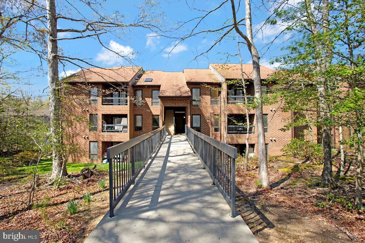 BRIDGE LEVEL Access - no steps! UNIT NUMBER ON DOOR IS #830. This Locust Ridge condo has beautiful views of the community pond an added amenities that other condo units in Wildewood don't offer such as in-unit sprinkler system, car washing station, and access to the pool and clubhouse. Condo dues are $240/mo and include trash and water utilities. The assigned parking is close to the condo and guest parking spots are also nearby. There are 2 BRs, 1.5 bathrooms. The primary bedroom has a WIC w/ attached half bath. The balcony overlooks the pond and offers a nice space to sit outside. Great investment property as bridge level units are in demand!
