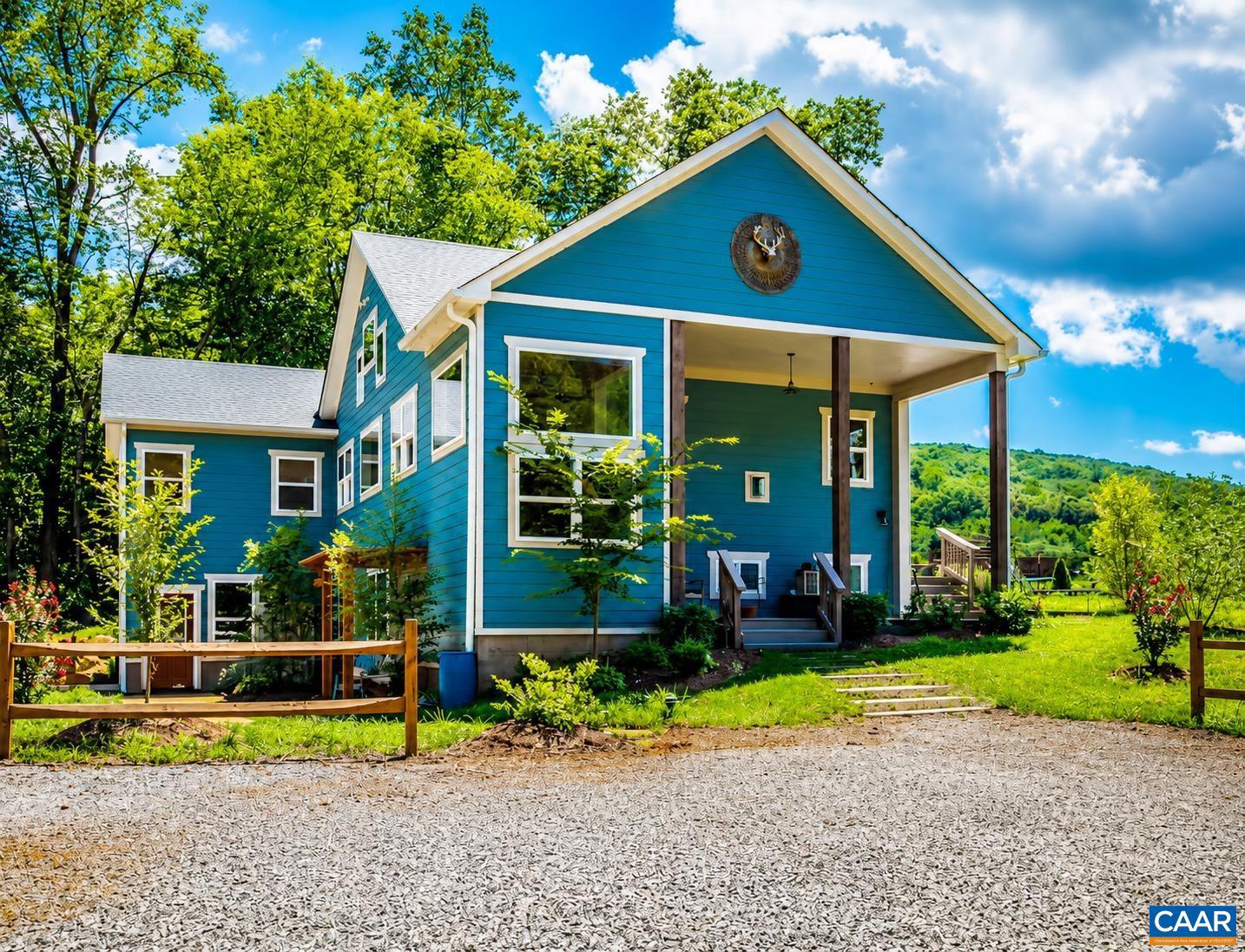 Set on over 20 private acres just minutes from Charlottesville and Wegmans, this exceptional property offers breathtaking mountain views and a rare combination of craftsmanship, comfort, and convenience. The main residence, built in 2015, features over 3,000 finished sf with 3 bedrooms and 2� baths. This stunning white oak timber frame home was thoughtfully designed and custom-built with beams hand-selected by the owner, who brings over 45 years of experience in the timber industry. The home offers true one-level living with an open floor plan, soaring ceilings, abundant natural light, and beautiful oak flooring throughout. A striking cherry bar and custom gas fireplace mantel?crafted from a tree sourced directly from the property?create a warm and inviting focal point. The spacious kitchen features quality cabinetry by Cabinets by Design. Outdoor living is equally impressive, with expansive deck space overlooking nearly level land, a koi pond, a spring-fed duck pond, and a firepit?all framed by sweeping mountain views. Additional improvements include a barn (approximately 52? x 16?), an outbuilding with a separate electric meter, and a charming guest house w/full bath, loft and private deck.  Convenient access to Rt 29 and I-64,Granite Counter,Fireplace in Living Room