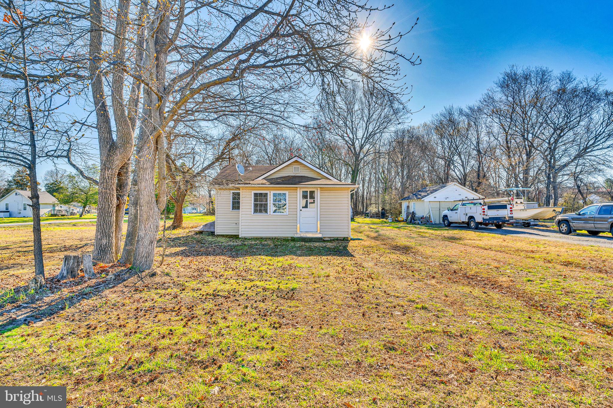 What an opportunity to own almost 2 acres on public sewer in Shady Side Maryland.  This super cute 1940's cottage offering 2 bedrooms and 1 bath with a detached garage has so many options for a buyer.  Keep it the way it is and live the tiny house lifestyle or tear it down and build a new home for your family! Zoned R1 this will allow residential This District is generally intended for low-density suburban single-family detached residential development at a subdivision density of 1 dwelling unit per 40,000 square feet. Minimum lot size is 40,000 square feet. Maximum lot coverage by structures is 25%. Maximum height is 45 feet.  Nice location with water access just a short distance away perfect for the water enthusiasts who want to fish etc.  The solid garage is a great asset for the house and we have priced this one to move. Similar size homes have sold for almost $100k more in price. Being sold as-is yet it is in good condition.  Settlement will need to be negotiated as the seller needs to coordinate with their new purchase.
