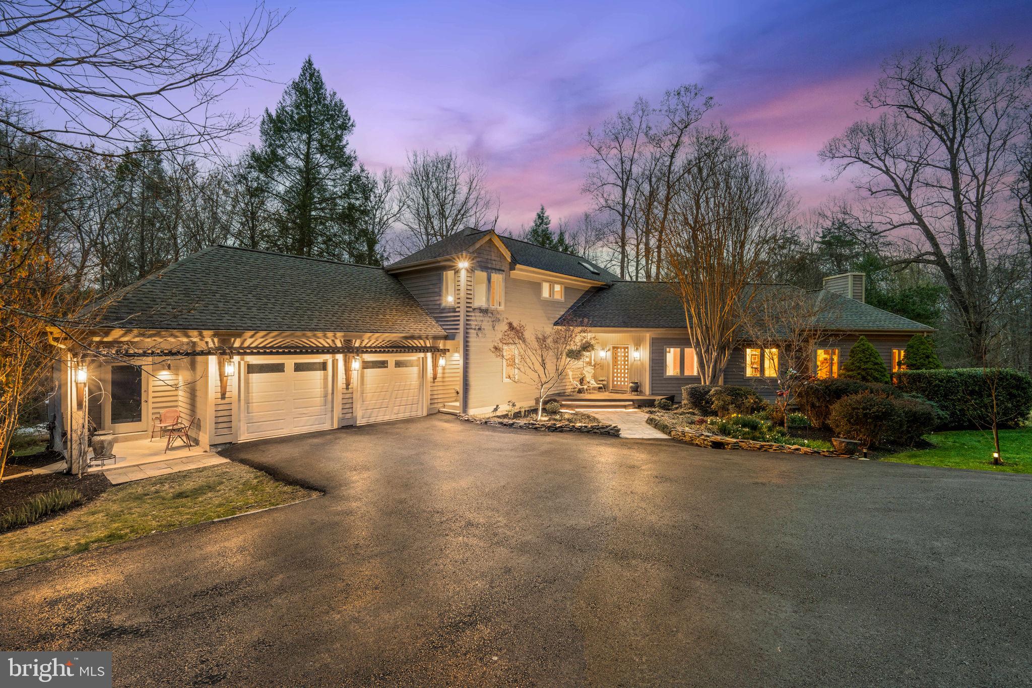 Don't miss the videos! If contemporary, private, acreage, nature, detail, natural light, clean line, gourmet kitchen, flowing space and main-level living are words and descriptions that pop up when you dream about a new home, this must be the home that comes to your mind. Impeccably designed and built, this one-of-a-kind retreat designed by Acorn Deck House Company seems to exemplify their brand perfectly: “The Acorn Deck House Company designs and crafts one-of-a-kind custom homes in modern, contemporary, and traditional styles, often a mix of all three.” This home is just that mash up, one that the photos will help you envision, but that you will really feel when you walk through it. This home is a masterclass in contemporary living in a rural/forested community.  Minutes from "downtown" Clifton, this house sits on nearly 7 forested acres, adjacent to Popes Head Creek and Hemlock Overlook Regional Park. The details of this property are endless; notice how the soaring ceilings, exposed beams, skylights, wood casework, hardwood flooring, fireplace-stone-surround and walls of windows blur the lines between inside and out. While the home is contemporary, the spaces are warm and inviting. The perfectly designed main level features: * a gourmet kitchen with Wolf appliances, a kitchen island, double ovens, a gas cooktop, anchored by a flex space (currently a casual eating area) with a wall of floor-to-ceiling forest-facing windows * a formal-ish dining room that is the glue between the kitchen and the living room. Framed by windows, built-in shelves and a soaring ceiling, this room is the perfect entertainment bridge between the kitchen and living room * a living room that feels airy, yet grounded simultaneously, thanks to the wall of windows, the vaulted ceiling, the wood-burning fireplace and the cozy window seat and built-in shelves between it and the foyer * a private Primary Suite with stunning forest views, vaulted ceilings, deck access, and a spa-like bath * a second main-level bedroom, currently used as a home office, with two walls of windows * a hallway full bath * a large mud room / laundry room off of the garage and side patio * The upstairs is a carve out for two bedrooms (one with its own playroom/office/yoga room attached), a hall with its own "niche" for an inviting space to enjoy reading or playing guitar or ? * another full bath rounds out this level * And then there’s the sprawling lower level, a space limited only by your imagination! * two oversized rec rooms, currently a game room (the pool table conveys) with access to the patio and a TV/guest room * the fifth bedroom and the fourth full bath * 900+ square feet that is currently a home gym, but is a blank slate for future buildout or …? * Ready for fresh air? The exceptional forest oasis awaits, and there are so many places to enjoy the outdoors * on a vast Cumaru (Brazilian teak) wrap-around hardwood deck * on a large patio space protected from the elements by the deck above * around the fire pit extraordinaire ensconced in the forest *on the multitude of trails cleared throughout the acres of forest for motorcycles, mountain bikes, walks (or a horseback ride?) * on the lush lawn for yard games. * Updates to the house since 2021 include painting the upstairs bedrooms and replacing the carpet/upgraded padding upstairs (2025), Wolf kitchen appliances, a 75-gallon hot water tank, resurfacing the driveway (2024), clearing and creating the fire pit area and creating trails. * Other highlights of this home include that this house is surrounded by an HOA, but it is not part of it. * The septic drain field has room for expansion, should you want to add an out-building. * It is @20 minutes to the Burke VRE and @30 minutes to the Franconia-Springfield Metro. * A rent back through late June is preferred. This unique property is a rare find, you won't find another like it. Don't miss out on this architectural, yet welcoming, delight of a home! * exterior cameras