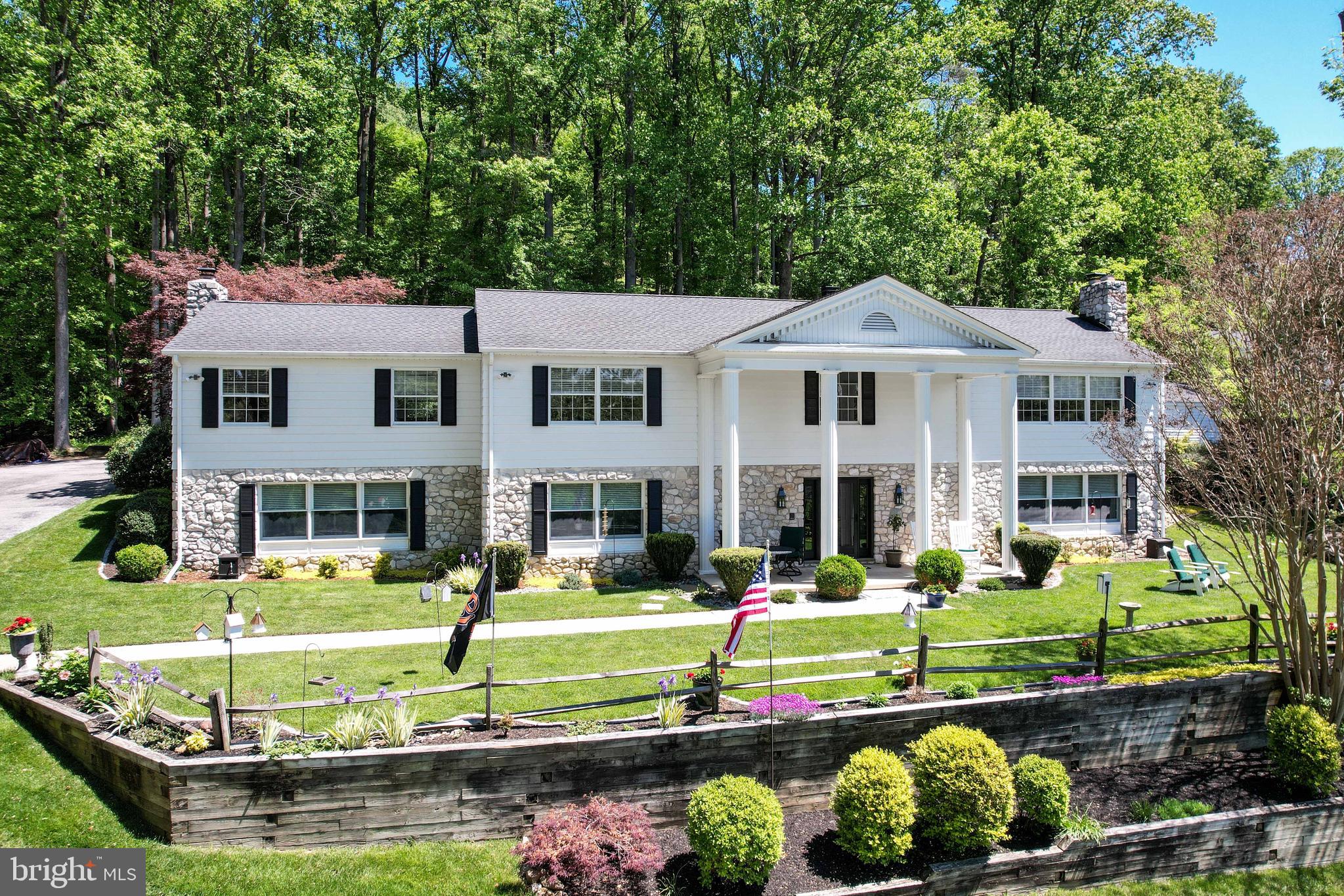 *Welcome to 13411 Blythenia Rd*Tucked away on a private 2.67-acre wooded homesite in the rarely available & highly sought-after “Cambria” neighborhood, this exceptional custom residence offers a rare opportunity just moments from the scenic Loch Raven Reservoir watershed trails & NCR Trail nature areas*Surrounded by mature trees & peaceful natural beauty, this one-of-a-kind property combines privacy, versatility, & timeless craftsmanship while still offering convenient access to everyday amenities* Homes in this established enclave rarely become available, especially those offering true multi-generational flexibility with two levels of main-level living, including 2 primary suites, 2 full kitchens, & 2 separate living & room spaces*

*Exterior features end of cul-de-sac location, private oversized driveway, 2 car detached garage with covered patio breezeway, sitting walls, plush rear yard, paver patio, deck area, & grandiose covered front porch with columns*

*Step inside through the dramatic foyer showcasing elegant hexagon tile flooring, fresh paint, designer lighting, & a stunning spiral staircase that immediately sets the tone for the home’s character & warmth* *The main level kitchen is beautifully appointed with upgraded cherry cabinetry, upgraded countertops, custom tile backsplash, stainless appliances, recessed lighting, & a table area*The formal dining room features real hardwood flooring, custom chair rail,  elegant lighting,  built-ins & French sliding doors leading to the great room*The main living areas are rich with charm & functionality, including a spacious great room with custom built-ins & one of 3 wood burning  fireplaces*The primary suite offers hardwood flooring, fresh paint, walk-in closet, & an updated bath with granite double vanity, ceramic tile flooring, walk in shower & upgraded fixtures*Additional bedrooms continue the hardwood flooring & fresh paint theme while the updated secondary full bath includes granite countertops, ceramic tile flooring, & tub/shower combo.

*The lower level & secondary living quarters create an incredibly rare setup ideal for multi-generational living, extended family, au pair accommodations, or private guest space*This thoughtfully designed area includes a second full kitchen with Corian countertops, custom cabinetry, stainless appliances, ceramic tile flooring, & additional dining space with wet bar and built-ins*A second spacious living room, oversized bedroom suite with beamed ceilings, recessed lighting, crown molding, fireplace, & private upgraded full bath provide comfort & independence rarely found in today’s market*

*Additional highlights include expansive utility/storage room with built-ins, dual washer/dryer setup, upgraded electrical service, water softener/filtration systems, geothermal HVAC system & dual oversized hot water tanks*

*This home is truly a rare offering combining luxury, flexibility, & nature in one extraordinary property*