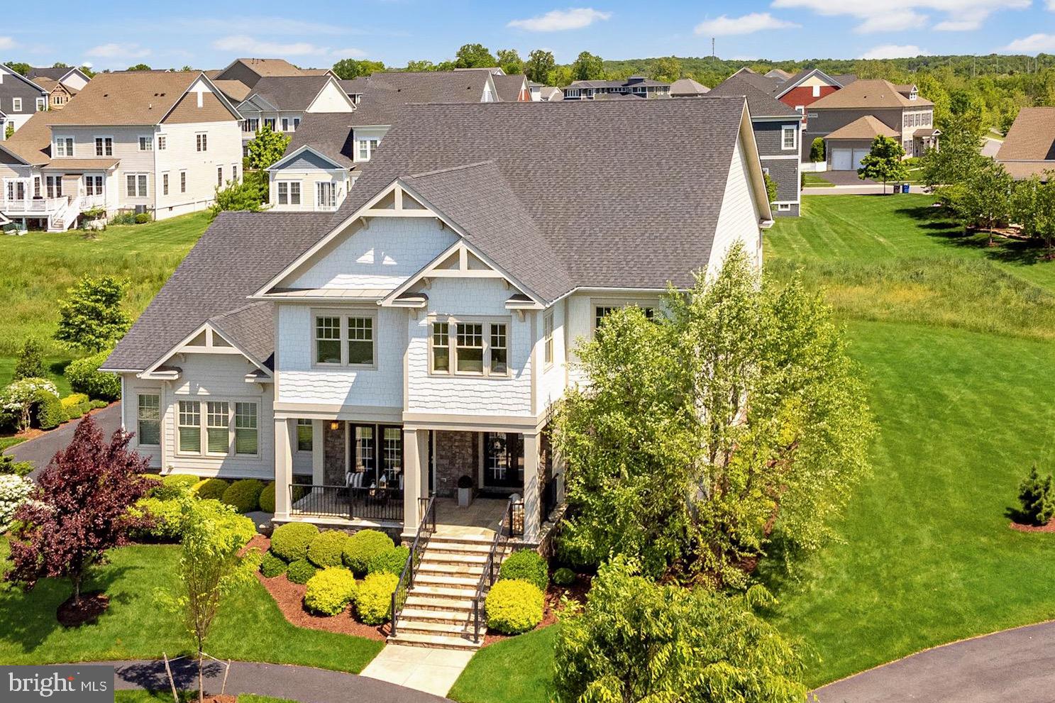 Simply the best of Willowsford with a designer showcase of unparalleled luxury and elegance! A top-of-the-line Timberneck model built by Arcadia Homes loaded with upgrades and custom features.  Thoughtfully designed and boasting an array of incredible qualities throughout including stunning fixtures, custom millwork, and Smith & Noble custom hardware and window treatments.  
<br><br>
From the flagstone front porch, glass French doors open to the entry foyer and main hallway which are accentuated with hardwood floors and modern fixtures.  A spacious living room is adjoined by the enclosed porch, which is complete with energy efficient, 4-season Sunspace WeatherMaster vinyl windows with lifetime warranties, Hunter Douglas remote-controlled exterior ceiling fan, and a floor to ceiling stone fireplace.  From here you can access the family room which proudly boasts a floor-to-ceiling Quartz surround fireplace and custom mantle, repurposed from an 18th Century barn.  Surround sound with in-wall subwoofers and a Visual Comfort chandelier make this room the most popular place to gather!  The family chef will be delighted with the gourmet kitchen, fully utilizing all of the tools including top-of-the-line GE Monogram appliances, pot filler, instant hot water, and incredible custom built-in pantry (10' x 15'). A massive island with contrasting cabinets, chandelier lighting, and seating further compliments the kitchen space.  Light filled casual and formal dining spaces, an incredible home office, and fully customized laundry and mudroom complete the main level.
 <br><br>
The opulent Primary Suite features a large bedroom with hardwood floors, a wet bar and kitchenette, and a luxury spa-like bathroom with heated tile flooring, heated towel rack, and warming lamp in the shower. The enormous walk-in closet is fully built out with custom cabinetry and lighting.  The upper level features a loft-style sitting area with built-in shelving and an enclosed patio accessible from the upper hall or ownerâs suite.  Three additional bedrooms all contain custom walk-in closets and designer fixtures.  Bedroom two is en-suite with an upgraded full bath.  Bedrooms three and four share a large bathroom and functional âkidâs officeâ.
 <br><br>
The Club Level features a huge recreation room complete with Dolby 7-channel surround sound and conveniences such as a custom wet bar, kitchenette, and wine cellar. The guest suite includes a large bedroom with a walk-in closet and opulent full bathroom. There is a custom secondary home office located adjacent to the rec-room, which is also a legal bedroom (making six total).  An exercise room and huge storage space complete the Club Level
 <br><br>
Perhaps the most impressive features are those that you wonât see upon a visual tour, including the smart home technology package.  This professionally installed system is complete with security cameras, a commercial network, and a whole-house audio system. Clean-up is a breeze with the BEAM Central vacuum that extends to all three levels.  The whole house humidifier, purifying UV lights, and the thermostatically controlled attic exhaust fans regulate the energy efficiency of the home.
 <br><br>
The oversized, side-load three car garage offers incredible storage options including an Elfa shelving/organization unit.  This prestigious craftsman is sited on a professionally landscaped lot on a quiet cul-de-sac.  A swimming pool, landscape, and hardscape design has already been fully approved by the HOA (see photo renderings).  Located in Willowsford, this community offers 2,000 acres of land set aside for environmental preservation, recreation, and agricultural use.  It has been named Community of the Year three years in a row!  Sought after Loudoun County schools, quick access to commuter routes, shopping, businesses and just minutes from future metro.  A marvelous opportunity to own an amazing property in this premier neighborhood.