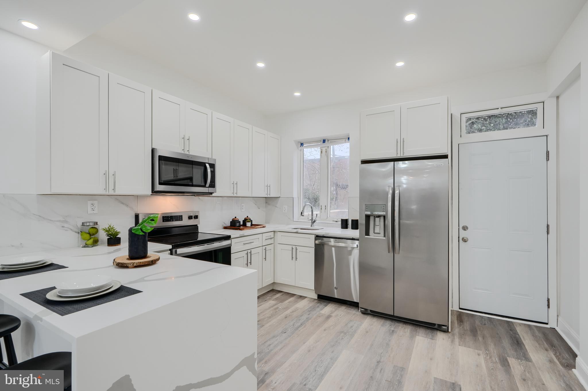 Welcome to 2707 Riggs Ave! This beautifully renovated home seamlessly blends modern design with comfort. Step inside to discover an open and inviting space featuring large windows that flood the home with natural light, luxury vinyl flooring, tray ceilings, and stylish lighting throughout. The gourmet kitchen is truly a showstopper, showcasing quartz waterfall countertops, a stunning backsplash, and stainless-steel appliances. A spacious breakfast bar provides ample seating, perfect for casual dining or entertaining. The formal dining room, highlighted by an elegant chandelier, offers a sophisticated space for gatherings. Upstairs, you'll find three generously sized bedrooms and a stunning bathroom that exudes luxury. The fully finished basement adds even more value, offering a full bathroom, an additional bedroom, a large recreation room, and convenient washer/dryer installed. Step outside to a large deck just off the kitchen, an ideal spot for summer BBQs and outdoor relaxation. The covered front porch adds another option for outdoor relaxation! Why rent when you can own this exquisite home? Don't miss the chance to make this beauty yours. Schedule your tour today!