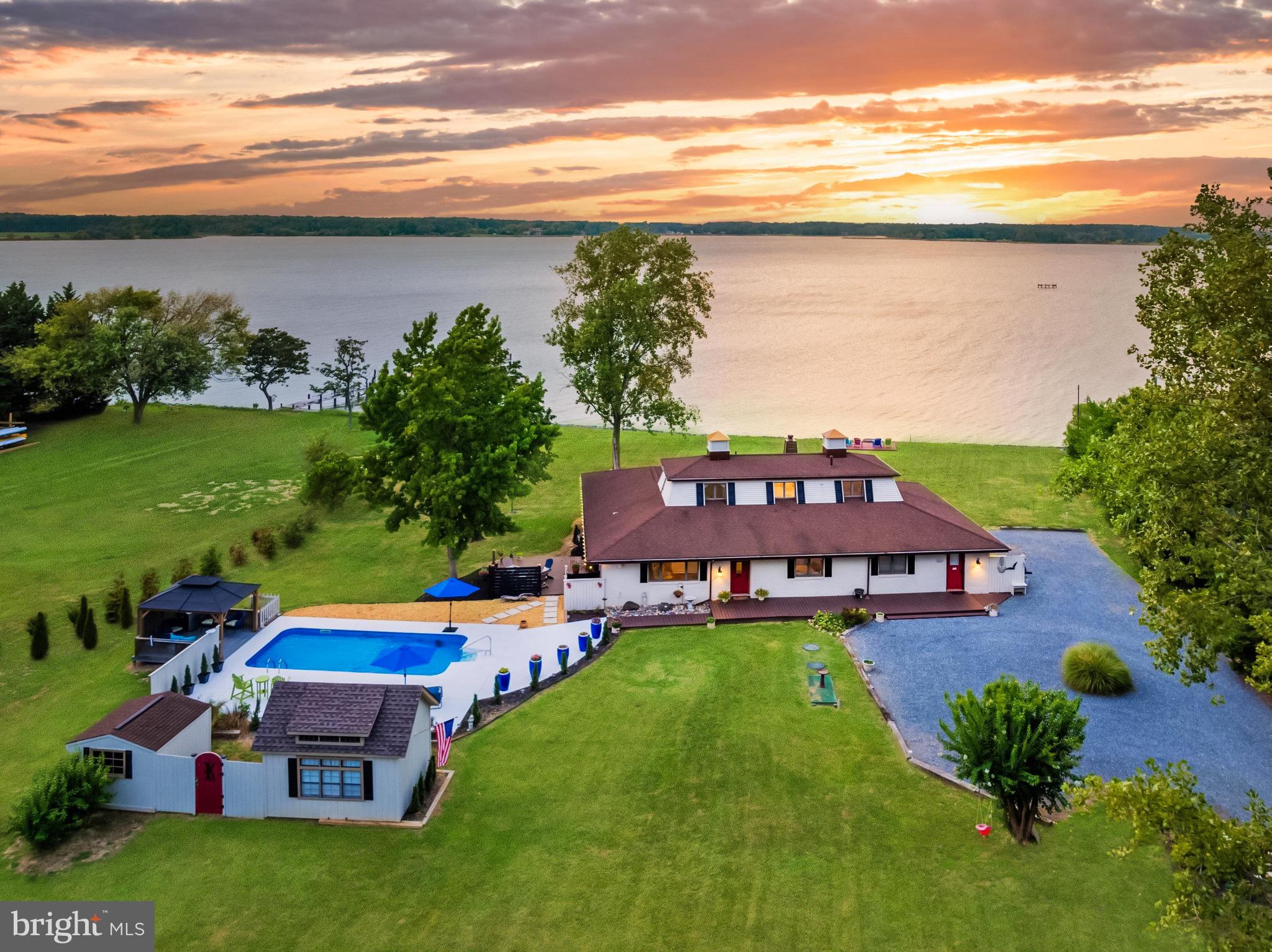 Whether seeking a peaceful residence or a weekend getaway, this home offers the ultimate waterfront lifestyle. Western facing with stunning year-round sunsets over Harris Creek, this home features 4 bedrooms and 3 full bathrooms, perfect for family and guests. The property is set on over 2 private acres with expansive views of Harris Creek, a protected Oyster Sanctuary and fabulous boating and fishing location. Outdoor living spaces are designed for relaxation and entertainment, featuring a new deck with an outdoor kitchen, perfect for alfresco dining, and a stunning pool with an expanded and refinished pool deck, gazebo, and storage sheds.

Inside, the updated kitchen boasts new appliances and countertops, creating an open layout ideal for entertaining. Multiple living areas and a dedicated dining room provide flexibility for relaxation and social gatherings. The centerpiece, the "River Room," offers the best views in the house, perfect for family gatherings or quiet reflection. This space, along with a screened-in porch, seamlessly connects to the outdoors and hot tub, allowing residents to enjoy the serene waterfront setting. The main level also includes a primary bedroom with breathtaking water views and a newly renovated  en-suite bathroom. An additional bedroom and full bathroom on the main floor add convenience. The two upper-level bedrooms share a beautifully updated bathroom, each offering panoramic views of Harris Creek. The expansive private driveway and attached 1-car garage provide ample parking space for residents and guests. 

Located just 10 minutes from the charming town of St. Michael's, this property offers a perfect blend of seclusion and convenience. The neighborhood, Indian Point West, is a special enclave of 23 homes. Community amenities include access to a kayak rack, boat ramp, and community pier, allowing for easy exploration of the surrounding waters. This home is adjacent to the community lot, with additional green space enhancing the sense of privacy and openness.

The combination of stunning natural beauty, modern comforts, and convenient location make 22476 Indian Point Road a truly exceptional retreat!