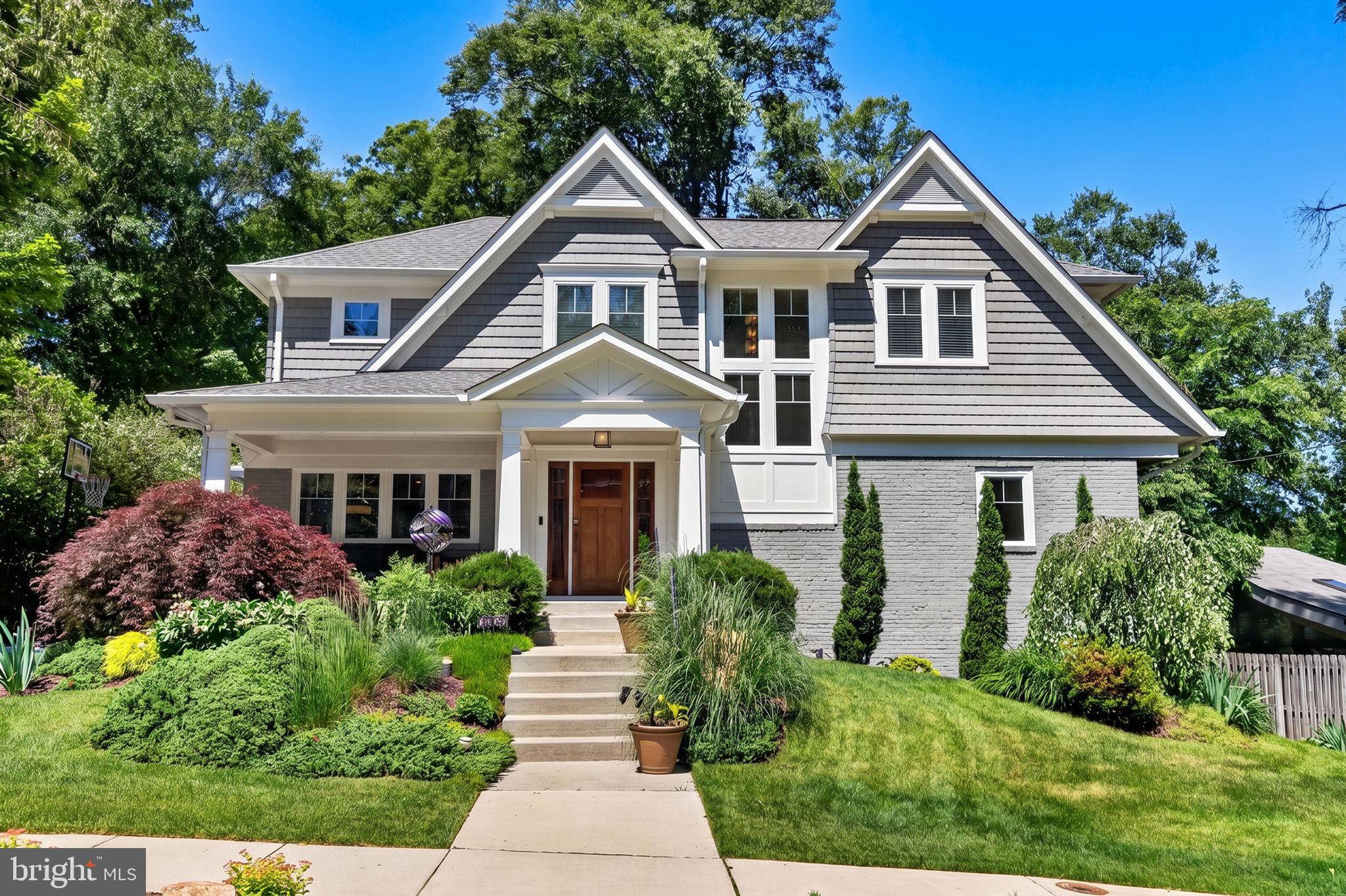 There are homes that are renovated, and then there are homes that are genuinely reimagined. This Craftsman beauty in Bethesda's Mass Ave Forest sits firmly in the second category. From the moment you arrive, the curated front garden, the covered porch with its beadboard ceiling, and the warm wood front door set a tone that carries through every room. <br><br>

Inside, the main level lives the way a family actually wants to live. The kitchen is the kind you cook in and linger in, with white shaker cabinetry, dark granite countertops, a gas range, and a big island that invites conversation while dinner is being made. A handsome built-in wet bar bridges the dining room and the great room addition, which is where the home truly reveals itself. Vaulted ceiling, LED cove lighting, a striking hand-crafted birch fireplace surround, and walls of windows looking into the trees create a room that feels equally right for a quiet Sunday morning and a dinner party for twenty. <br><br>

The confidence to enjoy all of this comes from knowing that everything behind the walls is new. Both the second floor and all major systems, including HVAC, electrical, plumbing, roof, and windows, were replaced or newly installed as part of two major permitted renovations completed in 2019 and 2022, representing more than $800,000 in improvements. The primary suite reflects that same investment, with a tray ceiling, LED cove lighting, a marble bathroom with frameless glass shower, and a custom walk-in closet. The finished lower level adds a media room with a wood-burning stove and a custom wet bar with wine refrigerator.  <br><br>

Step outside and the experience continues. A deck elevated into the treetops offers a perch above the sculpted garden below, while a covered pavilion at ground level wraps a seven-person Hot Spring hot tub with open-air window walls framing the flowering azaleas and mature trees. Heaters, an outdoor television, and built-in speakers mean this space gets used in January as happily as in July. A fully integrated smart home system, including Philips Hue lighting throughout, Brilliant in-wall control panels, and Ring security, all convey with the home.   <br><br>

The neighborhood amplifies everything. Merrimack Pool, a beloved member-owned community pool in the Bannockburn neighborhood with a seven-lane competition pool, diving well, kiddie pool, and swim and dive teams, is just steps away, and an equity membership conveys with the home. Glen Echo Park, the C&O Canal towpath, and the Capital Crescent Trail are minutes away. Downtown Bethesda is close. And this address feeds into Walt Whitman High School, one of the top-rated public high schools in Maryland.