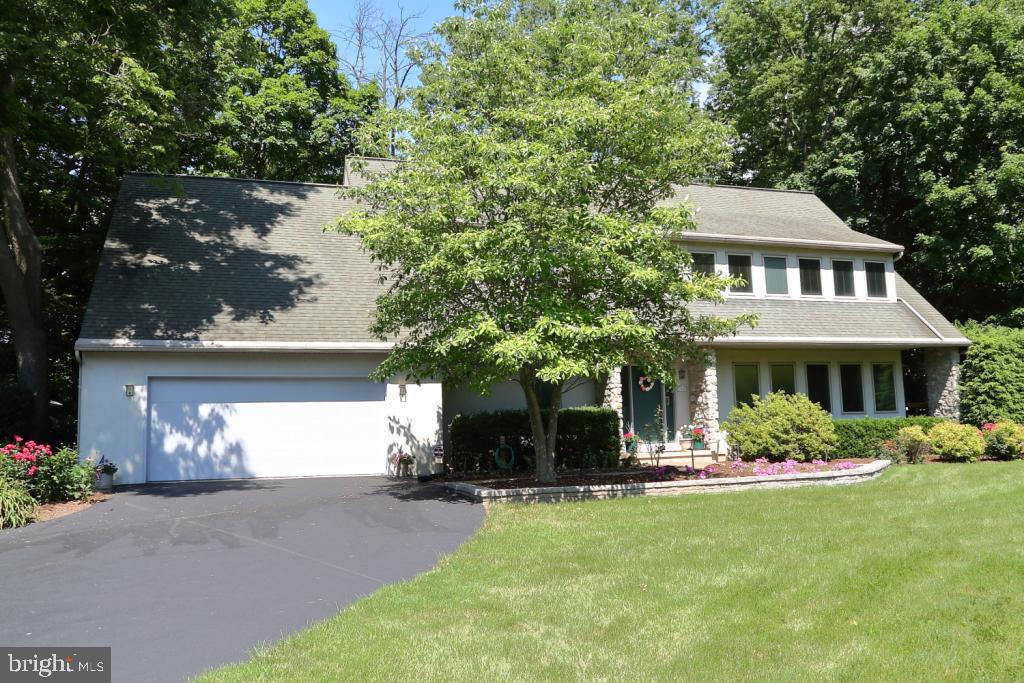 A fantastic Contemporary Home nestled on 2.5 acres of privacy in Manor Township close to schools, shopping and parks. As you enter the Foyer, leading towards the Breakfast Nook reveals a Panoramic View high above the Little Conestoga Creek! Open concept describes this home with a 2 Story Stone Fireplace in a spacious Living Room, First Floor Office, Breakfast Nook, Kitchen with Quartz Countertops and Backsplash, Dishwasher, Cooktop, Wall Oven, Built-In Microwave and Ceramic Tile Floor. From the Kitchen you walk into the Dining Area with built-ins then through to the Three Season Sunroom featuring a Hardwood Floor, Sliding Glass Door, Cove Lighting and a Vaulted Ceiling with a Ceiling Fan! Luxury Vinyl Tile Plank enhances the  Foyer, Office, Breakfast Nook and Dining Area. A convenient First Floor Laundry/Mud Room leads to an oversized Two Car Garage with an 11 Foot Ceiling and a Workshop Area! From the Foyer an open staircase leads to a spectacular Open Loft Area featuring a Library with Built-In Bookcases and an Office which overlooks the Living Room! An expansive Owners Suite features a Private Bath with a Whirlpool Tub and New Ceramic Tile Surround, Walk-in Shower (just remodeled), Double Vanity and a Walk-in Closet. Enjoy the view of the wooded area from the deck of the Owners Suite! The next Bedroom is spacious with built-ins shelves, Walk in Closet and a door entering the Main Bathroom. The third Bedroom has 2 closets with a Deck to relax on those warm summer evenings! All bedrooms have ceiling fans with a remote control. The home is heated and cooled with a Geothermal System that has Two Zones and Programmable Thermostats. All the windows are triple pane insulated with "Between the Glass Blinds"! The Central Vacuum System makes it super easy for cleaning! The exterior is an outdoor dream for those summer parties featuring a 3 Tier Deck, Gazebo with Electric and Shades, a Patio with Porcelain Tile and Lights on a remote control! A flagstone path with an Arbor leads you to a Minihouse/Shed equipped with a 220 volt line to supply your electrical needs and store all your garden tools! The driveway features an Alert Sensor that alerts the owner when someone enters the driveway and automatically turns on the parking area, walkway lights and the outside garage lights. A must see to appreciate all that this home has to offer!