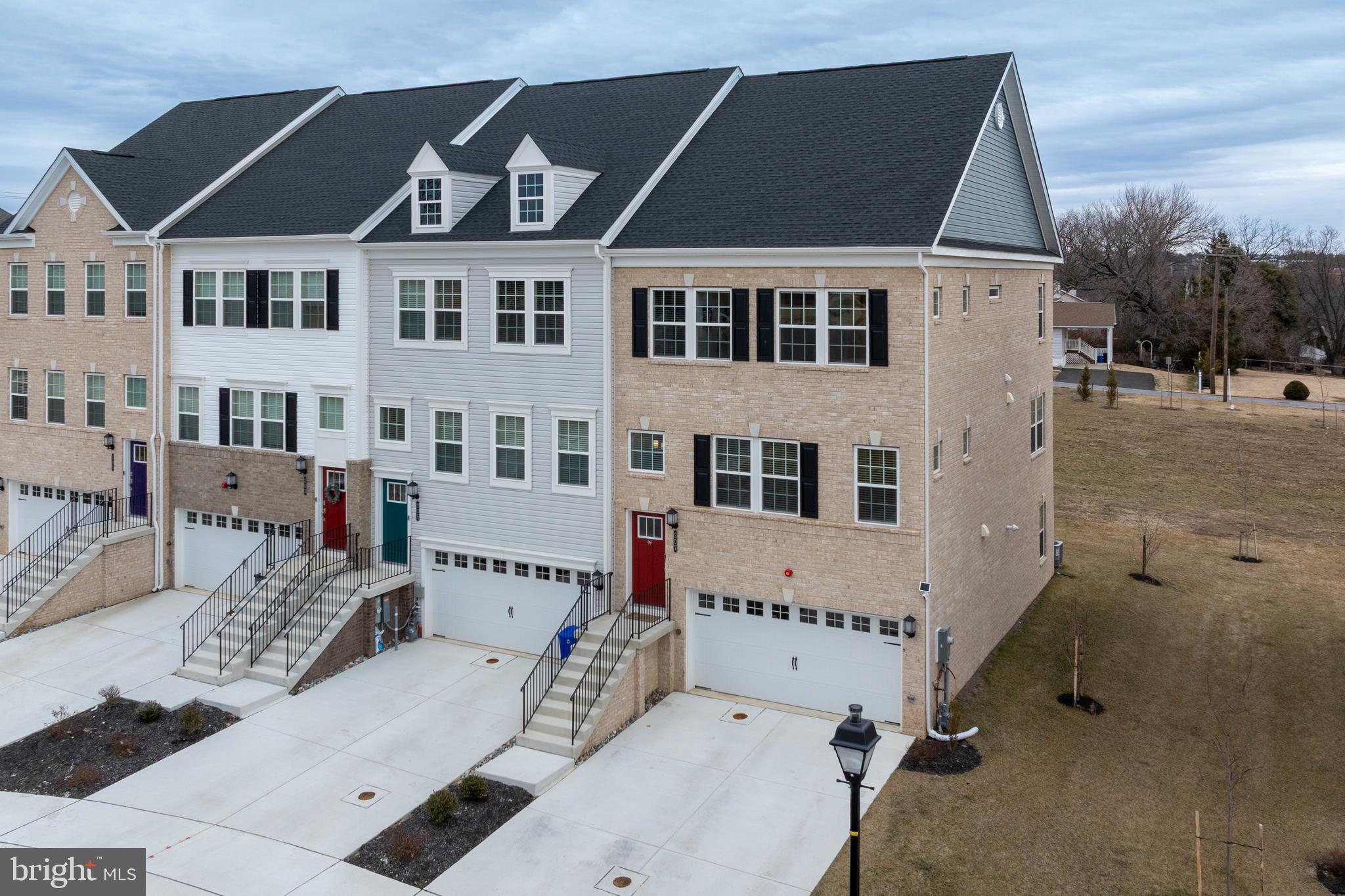 Price improvement and Open House! Make an offer! Exceptional four-level luxury townhome available in The Fairways at Woodholme, where refined design meets effortless living. This end-of-group residence showcases a striking double brick elevation and offers over 2,700 square feet of thoughtfully curated space, complete with the builder’s premier Designer Package.

Bathed in natural light and dressed in sophisticated neutral tones, the open-concept main level sets an elegant tone. The expansive living room is adorned with crown molding and recessed lighting, seamlessly flowing into the gourmet kitchen where wide-plank upgraded flooring continues throughout. Designed to impress, the kitchen features quartz countertops, an expanded island with generous seating, designer pendant lighting, subway tile backsplash, upgraded appliances, five-burner stove, and a double wall oven—creating the perfect setting for both everyday living and elevated entertaining. A spacious dining area opens through sliding doors to the main-level deck, blending indoor and outdoor living with ease. An elegant wine nook, oversized pantry, and stylish powder room complete this level.

Upstairs, the private bedroom level offers three generously sized bedrooms, including a serene primary suite designed as a true retreat. This sanctuary features two-piece crown molding, recessed lighting, remote-controlled blinds, large walk-in closet, and a spa-inspired ensuite bath with a frameless glass shower, dual vanities, quartz countertops, and designer LED lighting. Two additional bedrooms share a beautifully appointed full bath, also finished with quartz surfaces. A conveniently located laundry area on this level enhances everyday functionality.

The top-level loft provides a versatile bonus space ideal for a fitness studio, media lounge, or creative retreat. A half bath adds convenience, while a door leads to the rooftop deck—complete with a privacy fence—offering a peaceful setting for relaxing evenings or stylish entertaining under the open sky.

The fully finished lower level expands the living space with a spacious family room, full bath, and sliding doors to the exterior. This level also provides direct access to the oversized two-car garage, which includes additional storage space.

Located within an amenity-rich, highly sought-after community and just moments from premier shopping, dining, and major commuter routes, this exceptional residence delivers luxury, lifestyle, and location in perfect harmony.  Welcome home!