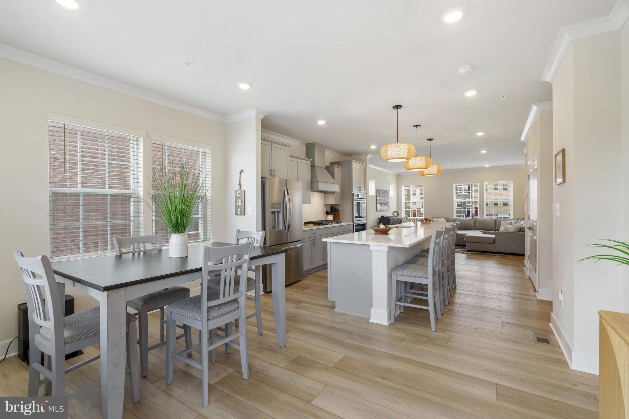 Exceptional four-level luxury townhome available in The Fairways at Woodholme, where refined design meets effortless living. This end-of-group residence showcases a striking double brick elevation and offers over 2,700 square feet of thoughtfully curated space, complete with the builder’s premier Designer Package.

Bathed in natural light and dressed in sophisticated neutral tones, the open-concept main level sets an elegant tone. The expansive living room is adorned with crown molding and recessed lighting, seamlessly flowing into the gourmet kitchen where wide-plank upgraded flooring continues throughout. Designed to impress, the kitchen features quartz countertops, an expanded island with generous seating, designer pendant lighting, subway tile backsplash, upgraded appliances, five-burner stove, and a double wall oven—creating the perfect setting for both everyday living and elevated entertaining. A spacious dining area opens through sliding doors to the main-level deck, blending indoor and outdoor living with ease. An elegant wine nook, oversized pantry, and stylish powder room complete this level.

Upstairs, the private bedroom level offers three generously sized bedrooms, including a serene primary suite designed as a true retreat. This sanctuary features two-piece crown molding, recessed lighting, remote-controlled blinds, large walk-in closet, and a spa-inspired ensuite bath with a frameless glass shower, dual vanities, quartz countertops, and designer LED lighting. Two additional bedrooms share a beautifully appointed full bath, also finished with quartz surfaces. A conveniently located laundry area on this level enhances everyday functionality.

The top-level loft provides a versatile bonus space ideal for a fitness studio, media lounge, or creative retreat. A half bath adds convenience, while a door leads to the rooftop deck—complete with a privacy fence—offering a peaceful setting for relaxing evenings or stylish entertaining under the open sky.

The fully finished lower level expands the living space with a spacious family room, full bath, and sliding doors to the exterior. This level also provides direct access to the oversized two-car garage, which includes additional storage space.

Located within an amenity-rich, highly sought-after community and just moments from premier shopping, dining, and major commuter routes, this exceptional residence delivers luxury, lifestyle, and location in perfect harmony.  Make your appointment today!