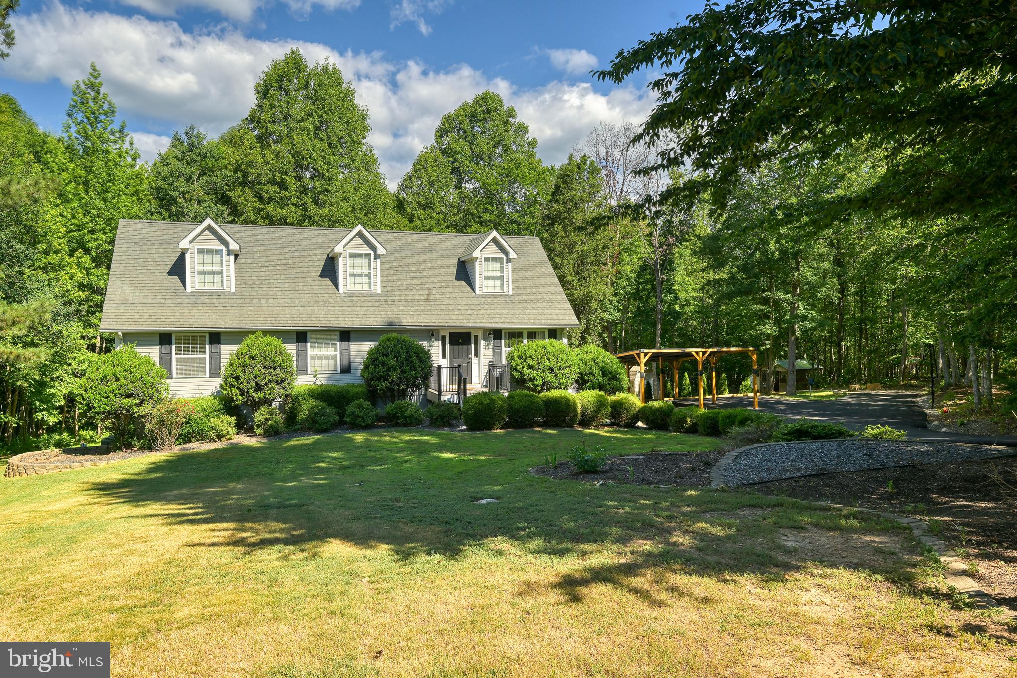 Welcome home to this beautifully maintained Cape Cod nestled on 1.7 private acres in a quiet cul-de-sac. Offering over 3,000 finished square feet, 5 bedrooms, and 3.5 bathrooms, this spacious home provides plenty of room for family, guests, and entertaining.
The main level features hardwood floors throughout the living room and kitchen, where you'll find butcher block countertops, plenty of cabinet space and a sunny eat-in dining area. The primary suite is conveniently located on the main floor and boasts an en-suite bath with double vanities and an impressive walk-in closet with ample space for storage and a dressing area. An additional bedroom and full bath on the main level offer flexibility for guests, a home office.
Upstairs, you'll find two generously sized bedrooms and a full bathroom. The finished basement expands the living space with a large recreation room, fifth bedroom, full bathroom, laundry area, and a versatile office or flex room.
Step outside and enjoy relaxing evenings on the back deck, perfect for grilling, entertaining, or simply taking in the peaceful surroundings while children and pets play in the spacious backyard. A newly paved driveway and carport provide ample parking and convenience.
Ideally located just minutes from I-64 and within easy reach of Mineral, Louisa, and Lake Anna, this property offers the perfect blend of privacy, space, and accessibility. Don't miss the opportunity to make this exceptional property your own!