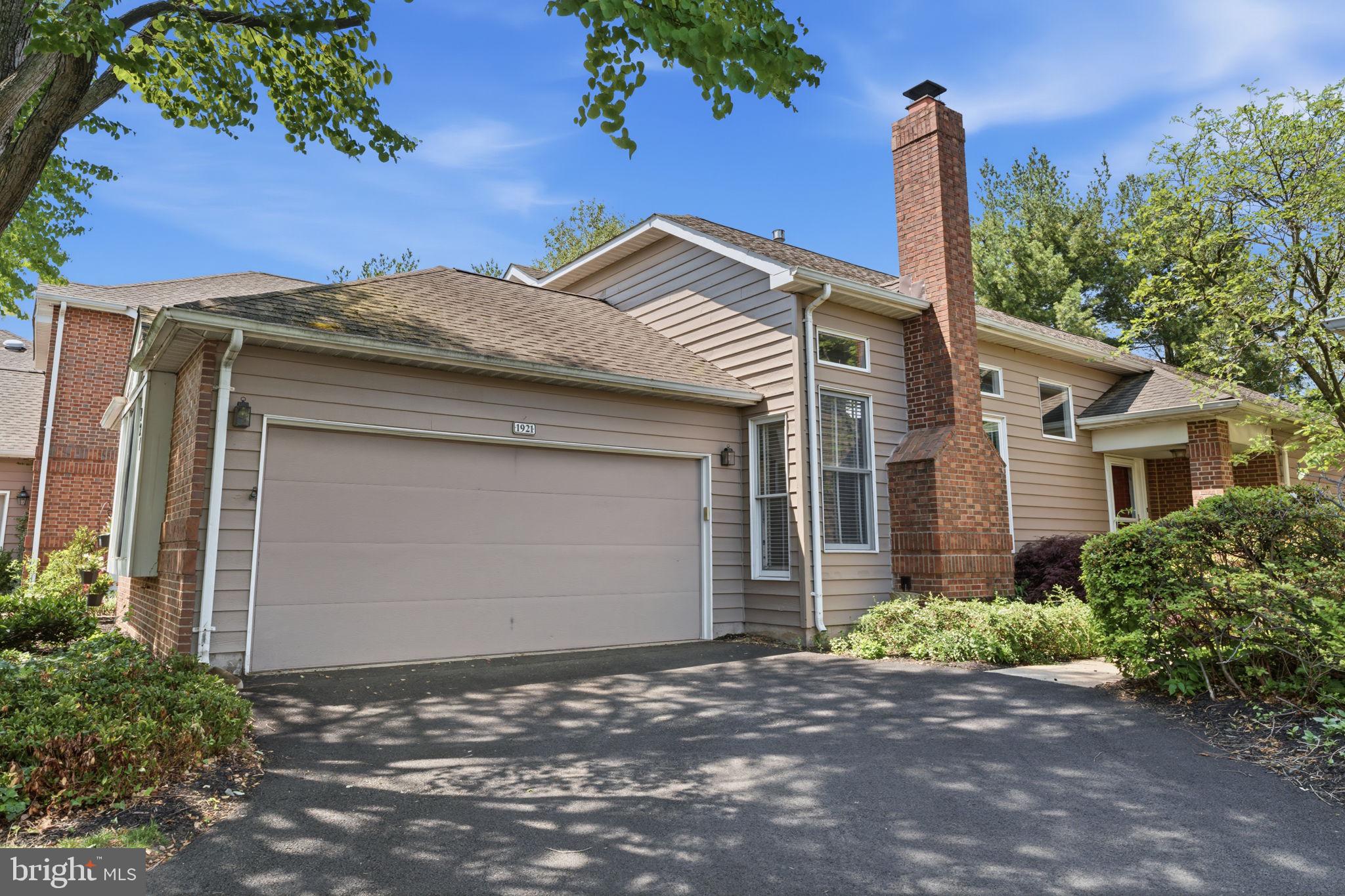 Welcome to this sun-drenched, move-in-ready residence blending modern elegance with a highly functional layout, which includes a first floor primary bedroom! The main level immediately impresses with an airy, open-concept great room boasting a wall of windows, cathedral ceilings, skylights, and seamless slider access to a private patio, as well as a large space for a table for bigger entertaining. The gourmet kitchen features hardwood cabinetry, stone countertops, stainless steel appliances, and a secondary dining patio. It flows effortlessly into a cozy family room centered around a classic fireplace flanked by oversized windows and topped with transom windows. Designed for versatile living, the main-floor primary suite offers a private retreat complete with a walk-in closet, deep-set windows, and a spa-like en-suite with a double vanity, soaking tub, and walk-in shower. An elegant open-view staircase leads to the upper level, which hosts two spacious bedrooms and a full bath. The beautifully finished basement extends your living space, providing an excellent media room, a fourth bedroom, and a bathroom—perfect for guests or multi-generational living. Freshly painted throughout and meticulously maintained, this home is ready for you to move right in. Enjoy the community pool, clubhouse and tennis courts. Super easy commute to all major corridors and simple 2 minute drive to groceries, restaurants  and convenient stores. Come see this stylish unique layout before it is too late!