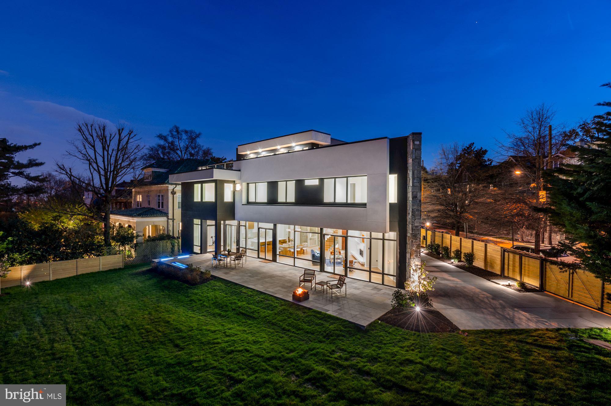 OPEN HOUSE 6/12 2-4.  Stunning new modern construction by INLE Development. Very private and completely hidden from the street by tall hedges, this exciting home has an expansive roof deck, floor-to-ceiling windows and multiple sets of glass doors that open to a large terrace and a lush, extremely private setting of over 11,000 square feet — ideal for entertaining.  A circular drive and large two-car garage can accommodate 6 - 8 cars.   The home has four levels of living space, all served by a glass elevator.  The first level has high ceilings and an open floor plan, plus a private office/den (or bedroom) with full bath and front and back staircases. Four bedrooms, each with its own bath, plus an office or study are on the second level, and a spectacular master suite on the top floor opens out to an extraordinary roof deck with unequalled views of the National Cathedral and the cityscape, including the dome of the U.S. Capitol.  The lowest level has 11’ ceilings and features a wet bar, a wine cellar, a full bath and additional living and entertaining space.  Potential to add a pool.