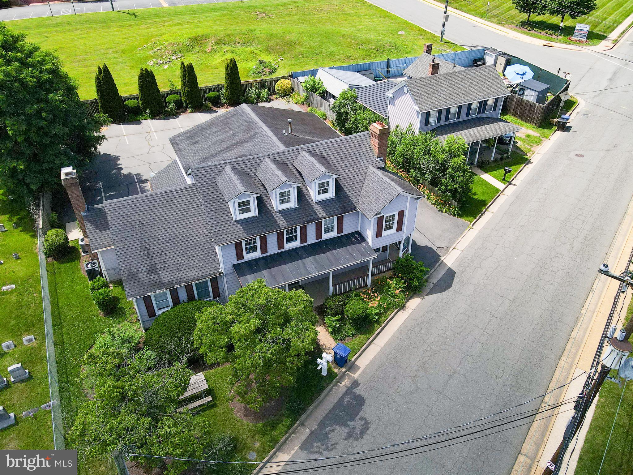This exceptional commercial property, built in 1890, presents a unique investment opportunity in a prime location near historic downtown Leesburg.  With multiple usage possibilities, this 3,200 sf building offers a blend of sophistication, functionality, and convenience.  Rebuilt from its historic foundation in 1980 while retaining unique architectural details, this building seamlessly merges classic charm with modern efficiency.  The property is strategically positioned for easy access and the paved parking lot provides ample parking space, ensuring convenience for visitors and employees alike. The main level is currently a legal suite featuring a large primary office, five separate offices, and a conference room.  You'll note hardwood floors, vaulted ceilings, an eat-in kitchen and two half-baths, merging to creating a highly functional and professional environment.  This main level space is occupied by one tenant in a long-term lease, currently in the fourth year of a five-year initial term and with two five-year options remaining.    The upper level is accessible via a separate entrance or the interior stairway connecting both levels, and is designed as a medical suite including a waiting/sitting room, administrative office space, a nursing work area and examining rooms. This level also features one half-bath and one full-bath with a shower, offering convenience for a myriad of medical or professional uses.  The entire upper level is operating under a one-year lease, thru February 2027,  and could offer a renewal opportunity for the current tenant or a fully available upper level for owner occupancy or creating multiple tenant opportunities.   Recent building improvements include new HVAC, new carpet and paint on the entire main level, and updated half-baths on the main level.  Exterior improvements include new professional landscaping, new exterior paint, and new roof shingles in the past ten years. The building sits on a 10,454 sf lot and includes its own private parking lot with 16 paved spaces, ensuring convenience for tenants and visitors. With easy access to major highways, public transportation, and nearby business hubs, this office building is an ideal location for corporate headquarters, professional firms, or growing businesses looking for a prime setting. High-speed internet, advanced security systems, and energy-efficient design further enhance the building’s appeal, while a modern lobby, conference rooms, and collaborative workspaces create a professional atmosphere. Don’t miss this exceptional opportunity to secure this premier building in a coveted location.

** COPIES OF CURRENT LEASES AVAILABLE UPON REQUEST **