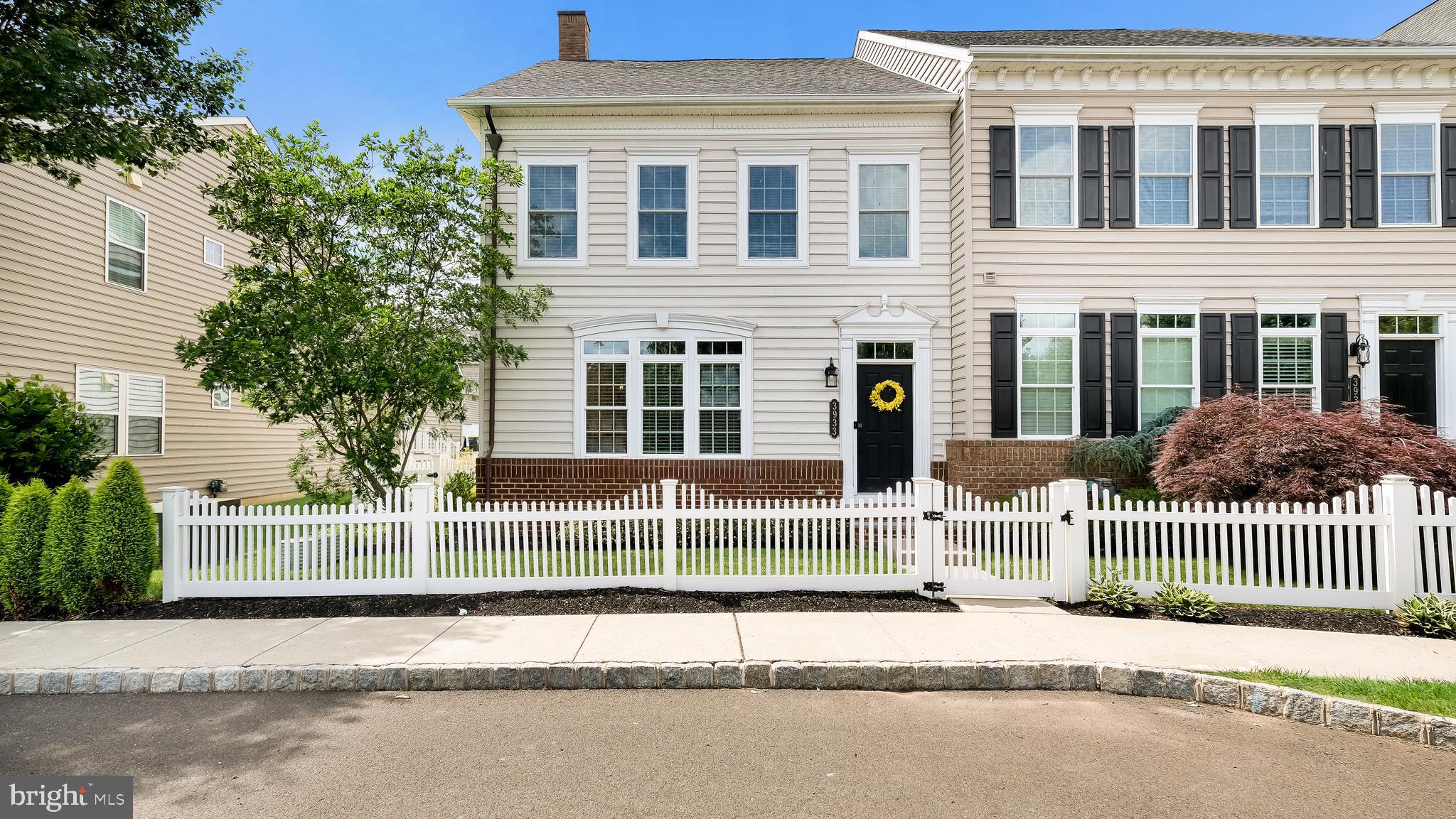 Welcome to this exceptional luxury end-unit town home in the highly sought-after community of Carriage Hill. Offering 4 bedrooms, 3.5 baths, a fully finished basement, and a detached 2-car garage, this beautifully maintained home combines elegant finishes, spacious living areas, and low-maintenance living.
From the moment you arrive, you'll appreciate the home's inviting curb appeal and picturesque setting overlooking open space. Inside, abundant natural light fills the open and airy main level. The spacious open  living/dining  area features a stunning new gas fireplace with a real brick surround, creating a warm and inviting focal point for everyday living and entertaining. Throughout the main level you'll find beautiful rustic flooring, crown molding and thoughtful architectural details. The gourmet kitchen is a chef's dream, featuring granite countertops, stainless steel appliances, a center island, pantry, and sunny breakfast area. Just off the kitchen, step outside to the deck, perfect for outdoor dining and gatherings, connecting to a paver walkway leading to the detached 2-car garage and private fenced side yard, providing additional outdoor space for relaxation, play, or pets. The second floor features a luxurious owner's suite complete with a striking brick accent wall, large walk-in closet with custom organization system, and an en suite bath featuring a double vanity, tile flooring, and an oversized walk-in shower with dual shower heads. Two additional bedrooms, each with custom closet systems, share a well-appointed hall bath. A convenient second-floor laundry room completes this level. The third floor offers a spacious fourth bedroom with two closets, a private balcony, and a full bath with a walk-in shower, making it an ideal guest suite, home office, or private retreat. The fully finished basement provides even more living space with split staircases leading to a large media room, game room, or second family room, along with a separate flex space perfect for a home gym, office, or hobby room. This home is also equipped with a Central Vacuum system. Located within walking distance to the nearby park featuring sports fields, playgrounds, and walking trails with view of the pond and open space. Conveniently located just minutes from the heart of Doylestown Boro’s shops, restaurants and cultural attractions. Carriage Hill offers true low-maintenance living with HOA services that include lawn care, snow removal, and trash collection. Located within the award-winning Central Bucks School District and offering easy access to New Jersey, Philadelphia, and major commuting routes, this remarkable home truly has it all!