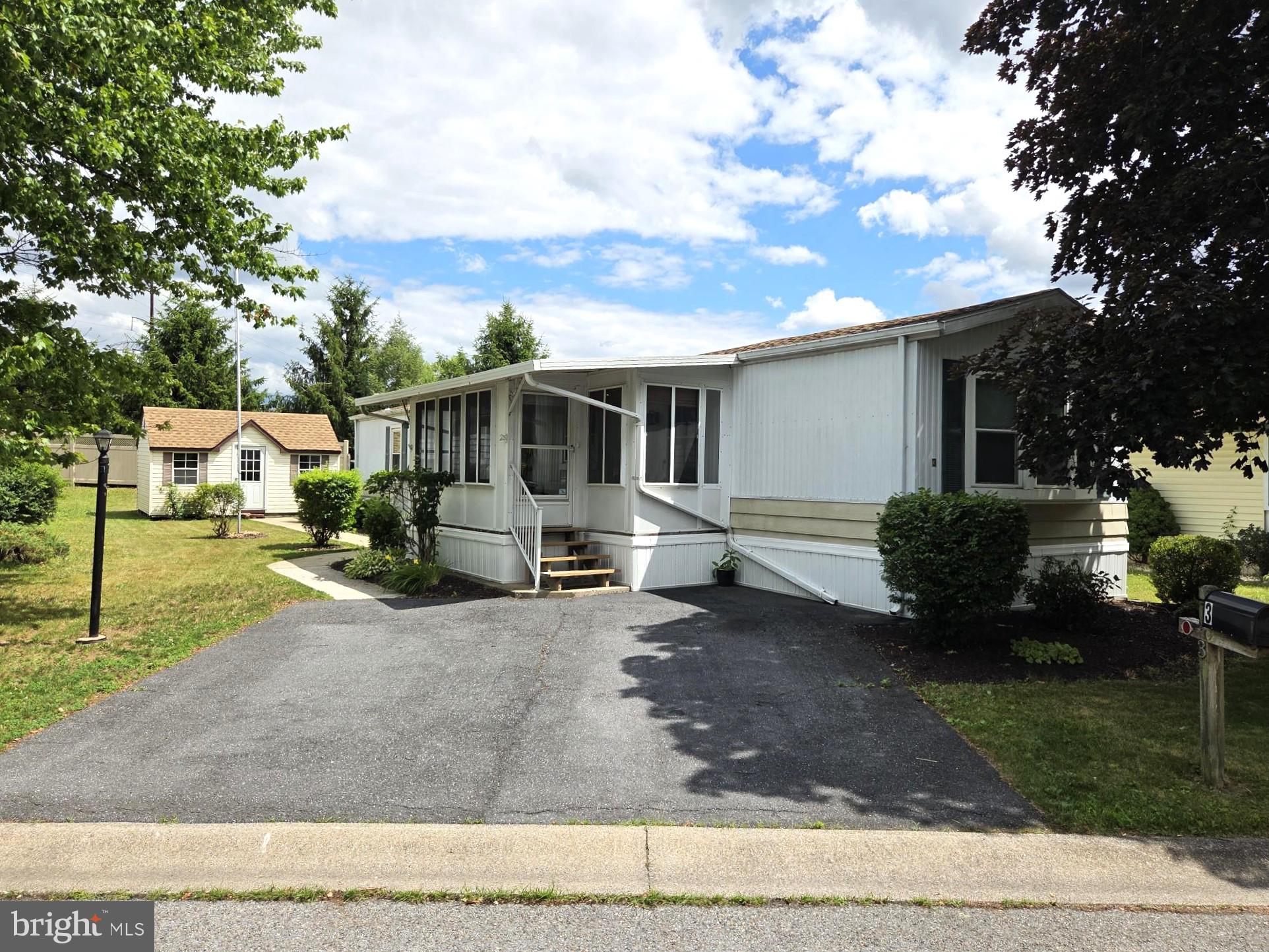 This beautifully maintained home in the 55+ community of Country Manor Farms features 2 bedrooms, 2 full baths, screened front porch, rear porch, central air, rear shed w electric and off street parking for 2 vehicles. Updates include water heater 2024, vinyl plank flooring 2021, windows 2020, wood deck 2019, skirting 2019, furnace 2018, central 2018 and roof 2018. The kitchen includes a breakfast bar, gas range, microwave and refrigerator. The large rear shed has electric and provide ample storage. The front bedroom adjoins a full bath that can also be accessed by a second entrance for use as a powder room. The primary bedroom has a ceiling fan, walk-in closet and private full bath. The laundry area to the rear of the home has overhead cabinets and includes a washer and dryer.