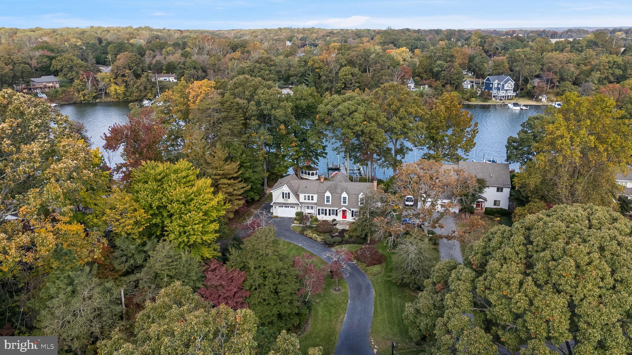 Welcome to a luxuriously crafted waterfront home where design and comfort meet the tranquility of coastal living. Perfectly positioned to capture sweeping views of Cuckold Creek, this residence showcases exceptional finishes and attention to detail throughout. The Hardie board exterior, accented by lush landscaping and a charming gazebo overlooking the shoreline and pier, evokes a timeless Dutch Colonial aesthetic with modern coastal flair.

Step inside and experience luxury and scenic water views at every turn — from the stunning owner’s suite, to the heated floors, to the showstopping kitchen featuring top-of-the-line appliances, including a Miele coffee system, and beautifully detailed cabinetry. The inviting living and dining spaces provide the perfect backdrop for entertaining or relaxing fireside while taking in the water views. Enjoy the convenience of TWO laundry rooms, one postured conveniently in the owner's suite and on the lowest level. 

Outside, your waterfront lifestyle continues with an impressive pier setup that includes a dock building equipped with an ice machine, refrigerator, and fish-cleaning station — plus power, water, and an outdoor shower. A 20,000 lb. boat lift makes accessing the open water effortless.

New irrigation system installed with space available to add a detached garage or pool, this property offers both refined living and room to grow. Come experience the unmatched beauty, craftsmanship, and serenity of this one-of-a-kind waterfront home.