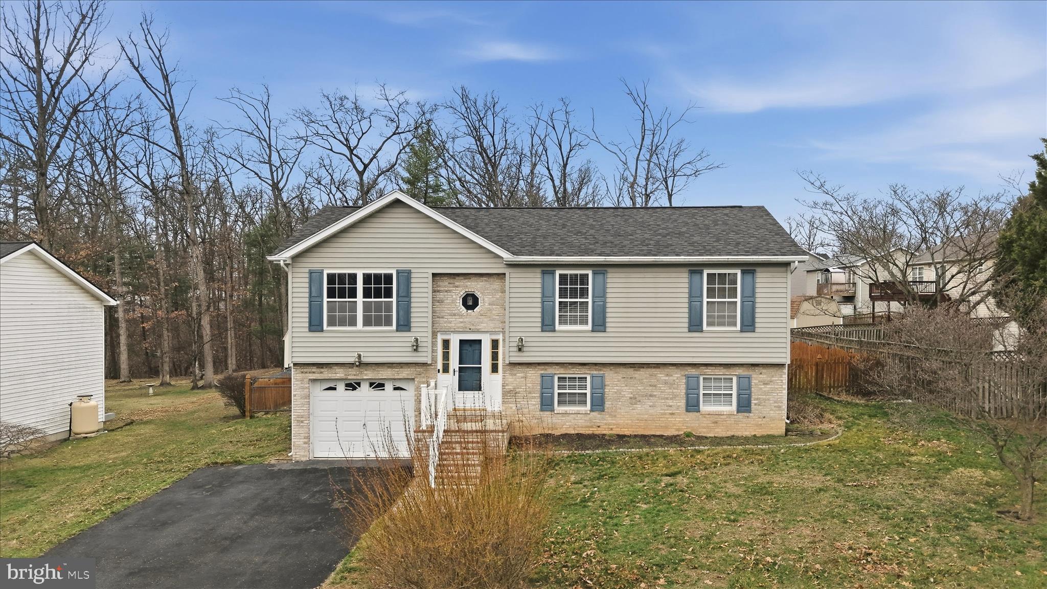 Well-maintained, single-owner residence backing to common area! Ideally located in Berkeley County south of Martinsburg city limits, this great home offers a quiet retreat within minutes of local amenities, thoroughfares, the VA hospital, Coast Guard facility, and IRS government offices. Updated flooring, fresh paint, a newer roof, and other updates provide peace of mind for years to come. In addition to a family room with vaulted ceilings, the main level also includes three bedrooms and two full baths. The lower level recreation area with pool table is a great hangout or multipurpose space with a rough-in for another bath and access to the fenced backyard. A large deck and attached single car garage enhance the functionality of this home. Don't wait to schedule a tour and make this one yours!