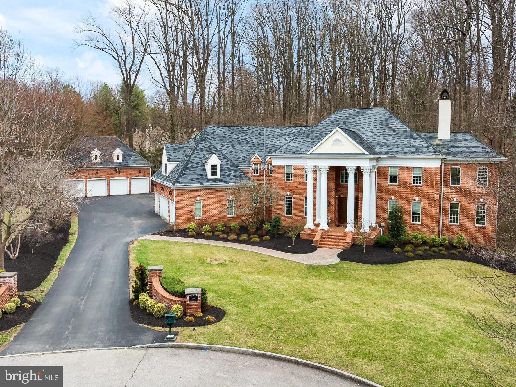 What if your getaway place was home? (TM) Experience life in the heart of the Main Line, where
you have convenient rail access to Center City and a high‐speed train to NYC just 5 minutes
away. The drive to Philadelphia International Airport is only 30 minutes. This property is located
in the award‐winning Radnor School District, with access to prestigious independent schools
and esteemed local universities. It also offers easy access to pharmaceutical, medical, and
financial centers.
Bryn Mawr is centrally located, providing excellent options for dining, exercising, local clubs,
sports facilities, and entertainment.
Nestled on 2 private acres—feeling more like 4 acres thanks to an additional 2 acres of open
space next door—this elegant Georgian Colonial home sits at the end of a cul‐de‐sac,
surrounded by beautifully styled residences. It boasts numerous unexpected features that
enhance its sophistication.
Upon entering this custom Dulgerian home, you are greeted by soaring columns and a sweeping
staircase that frames the grand foyer. The foyer offers a glimpse into the formal rooms. To the
left, the elegant dining room can accommodate twenty guests, while across the hall, the
exquisite living room captivates with its limestone‐carved fireplace. Just beyond the living room,
a warm and bright sunroom filled with greenery awaits.
At the heart of the home, an open floor plan connects all the main rooms. A great room, with a
wall of windows bringing in the natural landscape and a welcoming wood‐burning fireplace,
flows seamlessly into the chef's kitchen. This modern kitchen features light cabinetry,
professional‐grade stainless appliances, island seating, a butler's pantry, a walk‐in pantry, a wet
bar, and a breakfast room, making it the perfect space for entertaining.
A thoughtfully designed library, discreetly located behind the great room, offers a fireplace and
handsome cherry built‐in cabinetry, providing a tranquil workplace with picturesque wooded
views.
On the upper floor, the main suite serves as a wonderful retreat. It features a spacious bedroom
with a coffered ceiling, a fireplace, and plantation shutters. An adjacent sitting room boasts
spectacular views and is ideal for use as a gym or a second office. The spa‐like bathroom
includes a double shower, a large bathtub, an expansive vanity with double sinks, and
impressive cabinetry. Additionally, there are two walk‐in closets with built‐ins. On the other side
of the upper floor are two lovely bedrooms that share a Jack and Jill bathroom with double
sinks. Across the hall is an en‐suite bedroom with a private bathroom that has a shower and
vanity with double sinks. A tremendous in‐law or au‐pair suite with a generous private bath,
walk‐in closet, second closet, and a grand sitting area.
A spacious laundry room, conveniently located on this floor, provides access to the attic.

The lower level of the home serves as a walkout, extending across the entire floor plate and
featuring beautiful views of the woods and stream. It includes a large recreation room finished
with wainscotting, providing ample space for play and relaxation. Additionally, there is a wine
room (which could also serve as a safe room), a full bathroom, and a spacious storage area.
For car enthusiasts, this home is a dream come true, featuring four attached garage spaces.
There is also a detached two‐story garage that offers an additional four garage bays, along with
a finished room above and a powder room.