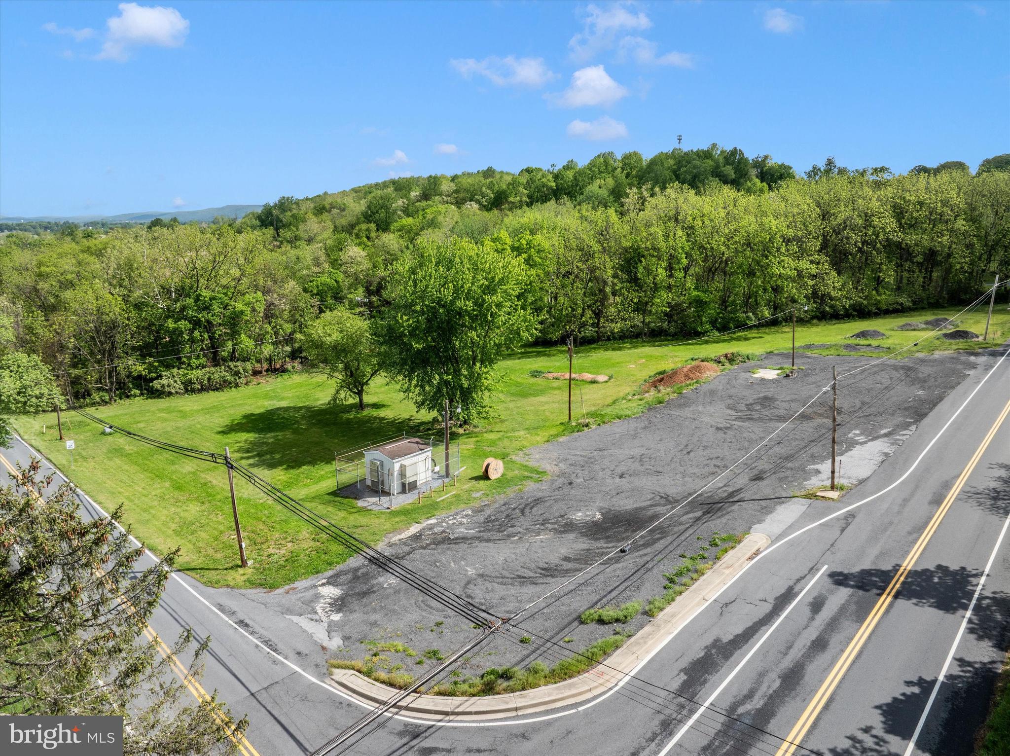 This premier 2.85-acre parcel is strategically zoned Village Center, providing a versatile foundation for a wide array of commercial and residential development opportunities. The site is currently serviced by public sewer with five active taps available for immediate use; however, it is important to note that any future building construction will require the installation of a private well system.

Development of the property is subject to existing power and gas line easements located across the rear of the lot. Additionally, Comcast maintains a permanent, rent-free fenced enclosure measuring 75' x 50' on the premises, which includes its own dedicated power line easements. While historical plats may reflect a slightly larger land area, these are provided for conceptual reference only. The official state tax assessment confirms the definitive acreage of the property as 2.85 acres, and all development planning should be based on this verified figure.