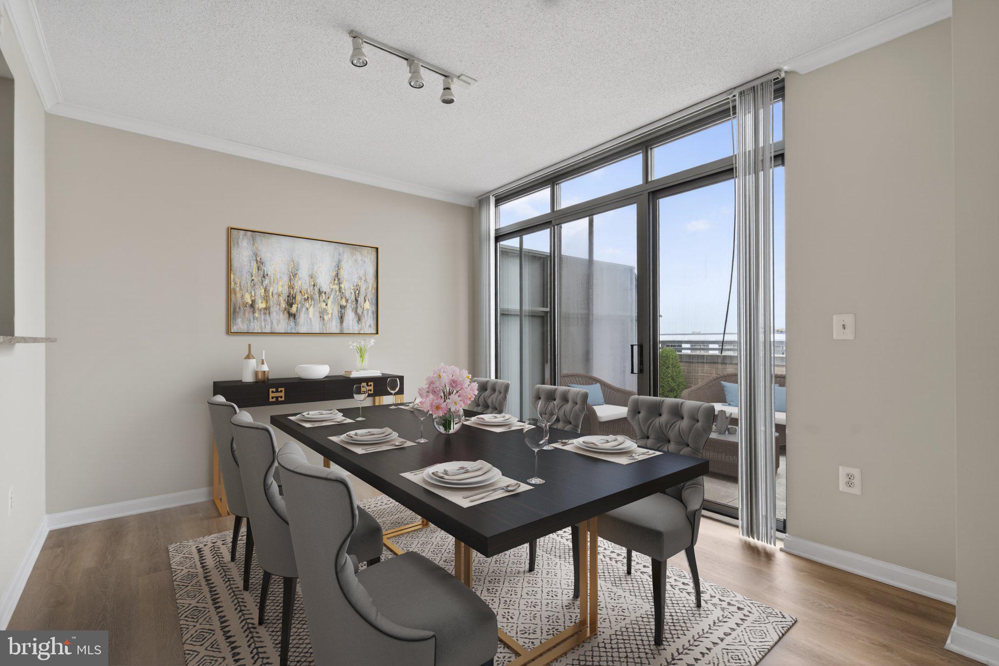 Nestled in the prestigious community of THE GALLERY, this corner unit 2-bedroom, 2-bathroom residence offers a luxurious lifestyle defined by elegance and comfort featuring high ceilings. Freshly painted with new floors.  Kitchen features granite counters, small table space, granite counters, oversized cabinets and a view into the living and dining rooms as well as the balcony. Also features side by side washer and dryer. The contemporary design features a master bedroom with large walk-in closet, separate dining and and living room including a cozy gas fireplace with glass doors, perfect for intimate gatherings. Step outside to discover beautifully landscaped grounds featuring extensive hardscapes, tranquil water fountain, terrace with numerous tables and chairs as well as a picnic table and gas grill BBQ ideal for entertaining. Enjoy the community's resort-style amenities, including an outdoor pool with lap lanes, 24 hour fitness center, and elegant lounge spaces that features a wet bar with kitchen, piano, billiards room, theater room, business center, meeting room, convenience store, assigned garage parking and 24 hour concierge. With a private balcony and wrap-around terrace large enough for patio furniture, plants or even a garden, this home invites you to savor serene moments while overlooking the meticulously maintained surroundings and is perfect for entertaining or relaxing. Experience the convenience of covered parking and a secure environment, all while being just steps away from vibrant community life Pike & Rose that features, numerous dining and entertainment options as well as a Farmer's Market on Saturdays.  Just 1 block away from Red Line Metro and minutes to downtown Bethesda, Rockville, Walter Reed, NIH and the DC line. Large end unit 2 bedroom 2 bath with HUGE wrap around balcony. ONLY 1 ASSIGNED GARAGE PARKING IS INCLUDED but there's a possibility a 2nd CAN BE PURCHASED AT AN ADDITIONAL COST AS WELL AS STORAGE FOR ADDITIONAL COST.