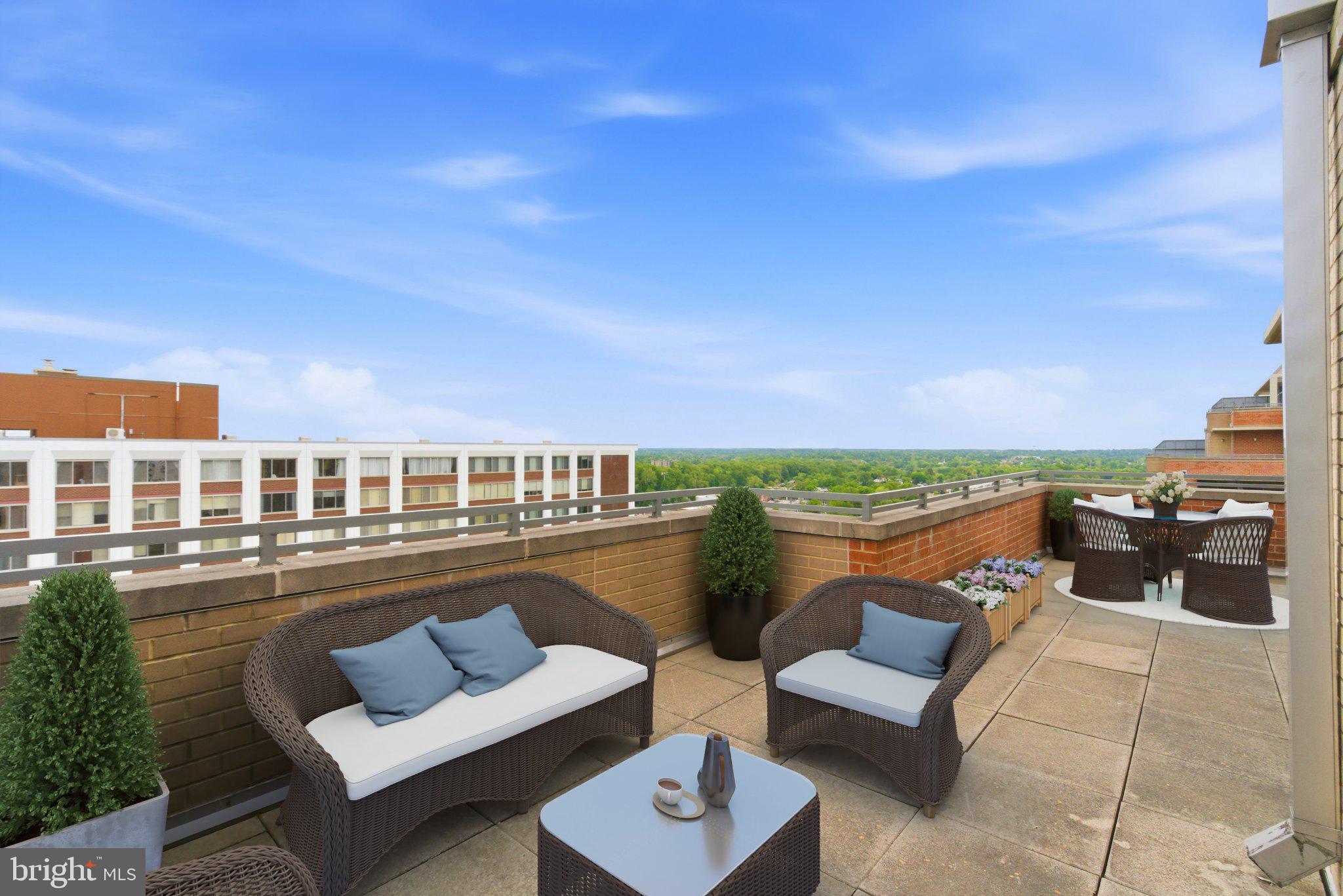 Nestled in the prestigious community of THE GALLERY, this corner unit 2-bedroom, 2-bathroom residence offers a luxurious lifestyle defined by elegance and comfort featuring high ceilings. Freshly painted with new floors.  Kitchen features granite counters, small table space, granite counters, oversized cabinets and a view into the living and dining rooms as well as the balcony. Also features side by side washer and dryer. The contemporary design features a master bedroom with large walk-in closet, separate dining and and living room including a cozy gas fireplace with glass doors, perfect for intimate gatherings. Step outside to discover beautifully landscaped grounds featuring extensive hardscapes, tranquil water fountain, terrace with numerous tables and chairs as well as a picnic table and gas grill BBQ ideal for entertaining. Enjoy the community's resort-style amenities, including an outdoor pool with lap lanes, 24 hour fitness center, and elegant lounge spaces that features a wet bar with kitchen, piano, billiards room, theater room, business center, meeting room, convenience store, assigned garage parking and 24 hour concierge. With a private balcony and wrap-around terrace large enough for patio furniture, plants or even a garden, this home invites you to savor serene moments while overlooking the meticulously maintained surroundings and is perfect for entertaining or relaxing. Experience the convenience of covered parking and a secure environment, all while being just steps away from vibrant community life Pike & Rose that features, numerous dining and entertainment options as well as a Farmer's Market on Saturdays.  Just 1 block away from Red Line Metro and minutes to downtown Bethesda, Rockville, Walter Reed, NIH and the DC line. Large end unit 2 bedroom 2 bath with HUGE wrap around balcony. ONLY 1 ASSIGNED GARAGE PARKING IS INCLUDED but there's a possibility a 2nd CAN BE PURCHASED AT AN ADDITIONAL COST AS WELL AS STORAGE FOR ADDITIONAL COST.