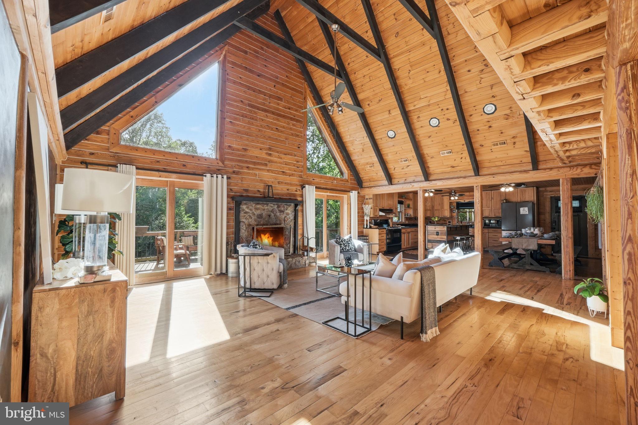 This nearly 6-acre private sanctuary offers the perfect blend of lifestyle and location. Start your mornings with birdsong on the front porch rocker and end your days with sunsets from the spacious back deck. Just a mile from Aquia Creek and the Potomac River, you’ll have easy access to Hope Springs Marina, Freedom Boat Club, and Aquia Boat Storage for endless recreation and relaxation. Inside, over 5,250 sq ft of custom chalet-style living awaits, crafted from kiln-dried Southland timber with 6x9 profile logs that resist rot and insects, and insulation equivalent to R39 for lasting efficiency. The flexible layout includes two upper-level offices that can convert to bedrooms, plus a main-level playroom with closet and full bath—ideal for an in-law suite or private guest space. Conveniently located minutes from I-95, VRE, shopping, and top-rated schools, it’s perfect for military families stationed at Quantico, Fort Belvoir, or Joint Base Andrews. Recent upgrades from 2021–2025 include dual HVAC units, a tankless water heater, two refrigerators, microwave, septic system and water purification, remodeled bathrooms, carpet replacement, smart/motion lighting, tree work, log treatment, and fence repairs. A 24x40-foot barn with attic trusses adds 600–700 sq ft of versatile space for work, storage, or creative projects in this agricultural/residential zone.