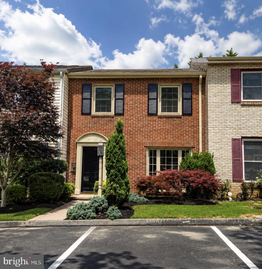 Meticulously maintained and thoughtfully updated, this elegant brick-front townhome offers a warm, inviting feel with designer touches throughout. Featuring three spacious upper-level bedrooms, a full bath, a convenient main-level half bath, a linen closet, and coat closet, the layout is both functional and refined. Solid wood flooring, ceramic tile, and laminate flooring blend seamlessly with fresh paint and replacement windows to create a bright, polished interior. Recent improvements include an approximately five-year-old HVAC system and a newer 50-gallon water heater for added peace of mind. Step outside and discover a true backyard retreat. Surrounded by lush landscaping, outdoor lighting, and anchored by a beautiful Japanese maple, the private oasis includes a brick walkway, patio, and covered canopy—an ideal setting for morning coffee, quiet evenings, or entertaining guests. Impeccably cared for and rich in character, this home offers a perfect balance of comfort, style, and low-maintenance living.