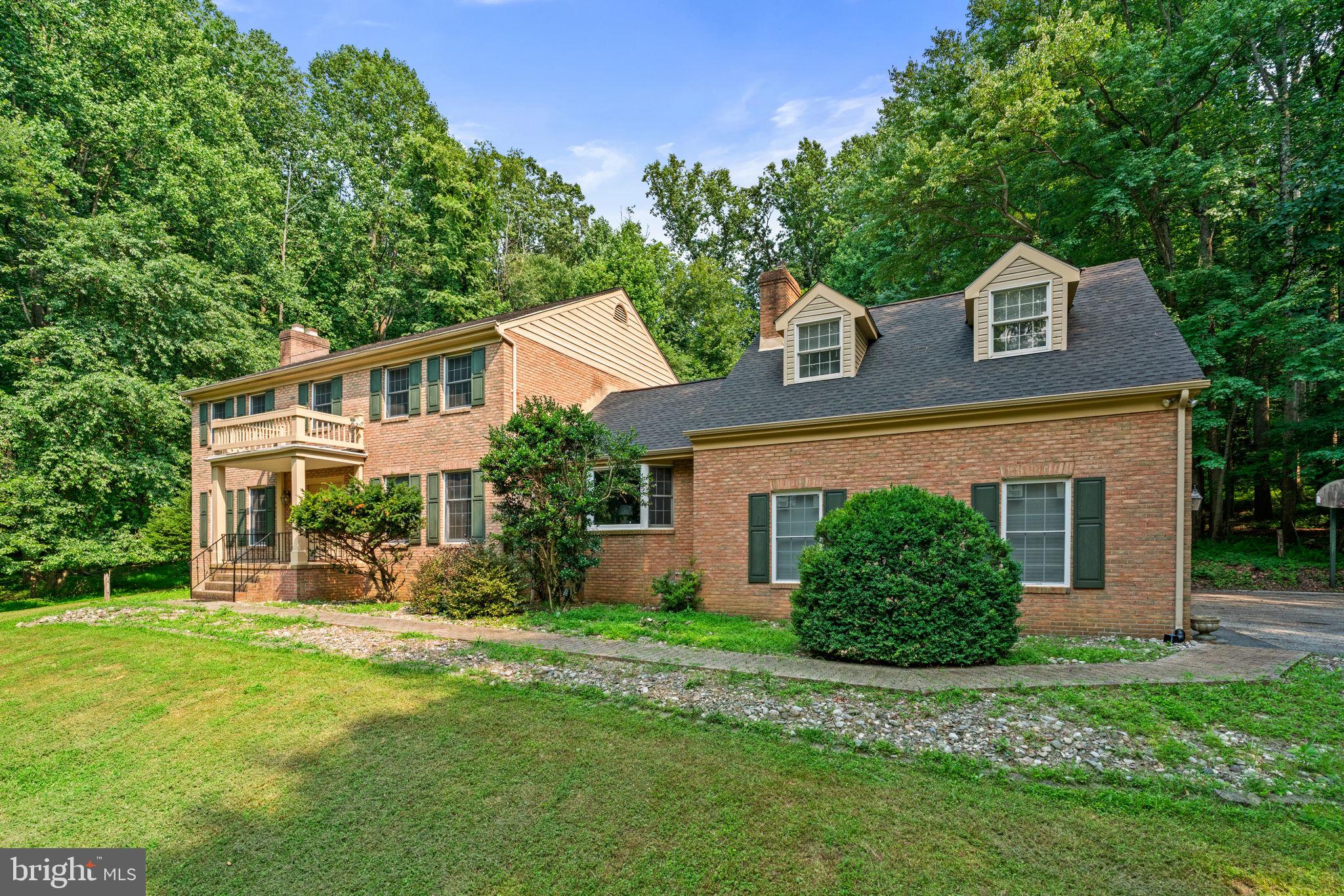 Welcome to Your Private Sanctuary –Tucked away on 3.04 private acres in the sought-after Windemere community, this custom brick estate offers the perfect blend of elegance, comfort, and peaceful living. Surrounded by nature and also located 9 minutes from I-695 & 36 minutes from BWI Airport, this 5-bedroom, 6-bathroom home is a calming space where every day feels like a retreat.  From the moment you enter those double doors, you're welcomed by a breathtaking 20-foot foyer, a graceful winding staircase & a stunning vintage Louis XV crystal chandelier that sets the tone for rest the home. With over 6.9k sq ft of thoughtfully designed functional space, this exceptional residence features 5 spacious bedrooms, 6 bathrooms, and hardwood flooring throughout. Whether you’re hosting holiday celebrations, entertaining friends, or enjoying a quiet evening at home, every room has been designed with comfort & connection in mind. The elegant living room invites cozy evenings around the marble fireplace, while the formal dining room is perfect for gathering with family and friends. The family room showcases soaring ceilings with exposed wood beams, stunning stone accent wall, push-button electric fireplace, Silestone quartz wet bar, rich Paraguayan oak flooring (2023), & a built-in Bose surround sound system—creating space to relax & entertain. Book lovers & professionals will appreciate the private library, with floor-to-ceiling built-in bookshelves & surround sound system. The inviting kitchen, featuring red oak cabinetry, Silestone quartz countertops, serving buffet, double ovens, & updated flooring (2023). Just beyond, step into your three-season sunroom with skylights, a serving buffet, and views of the surrounding landscape—making it the perfect place to enjoy morning coffee or unwind at the end of the day. The primary suite serves as a peaceful escape, offering 4 closets—including a cedar walk-in closet—a Jacuzzi tub, renovated shower (2023), updated flooring (2023), & double marble vanities. The finished lower level was designed with entertaining in mind -- and offers flexibility for today’s lifestyles. Featuring a six-seat bar, sink, abundant understated storage spaces, fridge/freezer, electric range & oven, serving buffet, fireplace, vintage renovated pool table (2024), hidden electronic movie screen, & built-in surround sound system, the functionality is endless. Whether hosting game nights, creating the ultimate media room, welcoming family, long-term guests or enjoying a private retreat, this space adapts beautifully. A private suite above the three-car garage provides more versatility, complete with a full bath, walk-in closet, and beautiful Paraguayan oak flooring (2023). Together with the spacious lower level, this home is exceptionally well suited for today’s lifestyles, offering comfort, privacy, & flexible living spaces for extended family, guests, or those who value room to spread out. Step outside and discover your backyard resort. The heated in-ground pool, reaching 15 feet deep is paired with a 6-person spa & surrounded by landscaped grounds. Ornate electric and solar lighting create a magical evening atmosphere, while the serene stone garden and crescent walking path offer peaceful places to relax & reconnect with nature. A convenient mudroom leading to the private pool bath make entertaining effortless. Located near parks and everyday conveniences, this remarkable property offers the privacy and luxury of an estate while remaining close to everything you need. More than just a beautiful home, this is a place where memories are made—where celebrations are special, quiet mornings are peaceful, & every season brings new reasons to fall in love with your surroundings. Come experience the warmth & exceptional lifestyle this one-of-a-kind Windemere estate has to offer. Come enjoy your hidden gem.  Welcome Home. Private showings by appointment. Buyer pre-qualification requested prior to scheduling