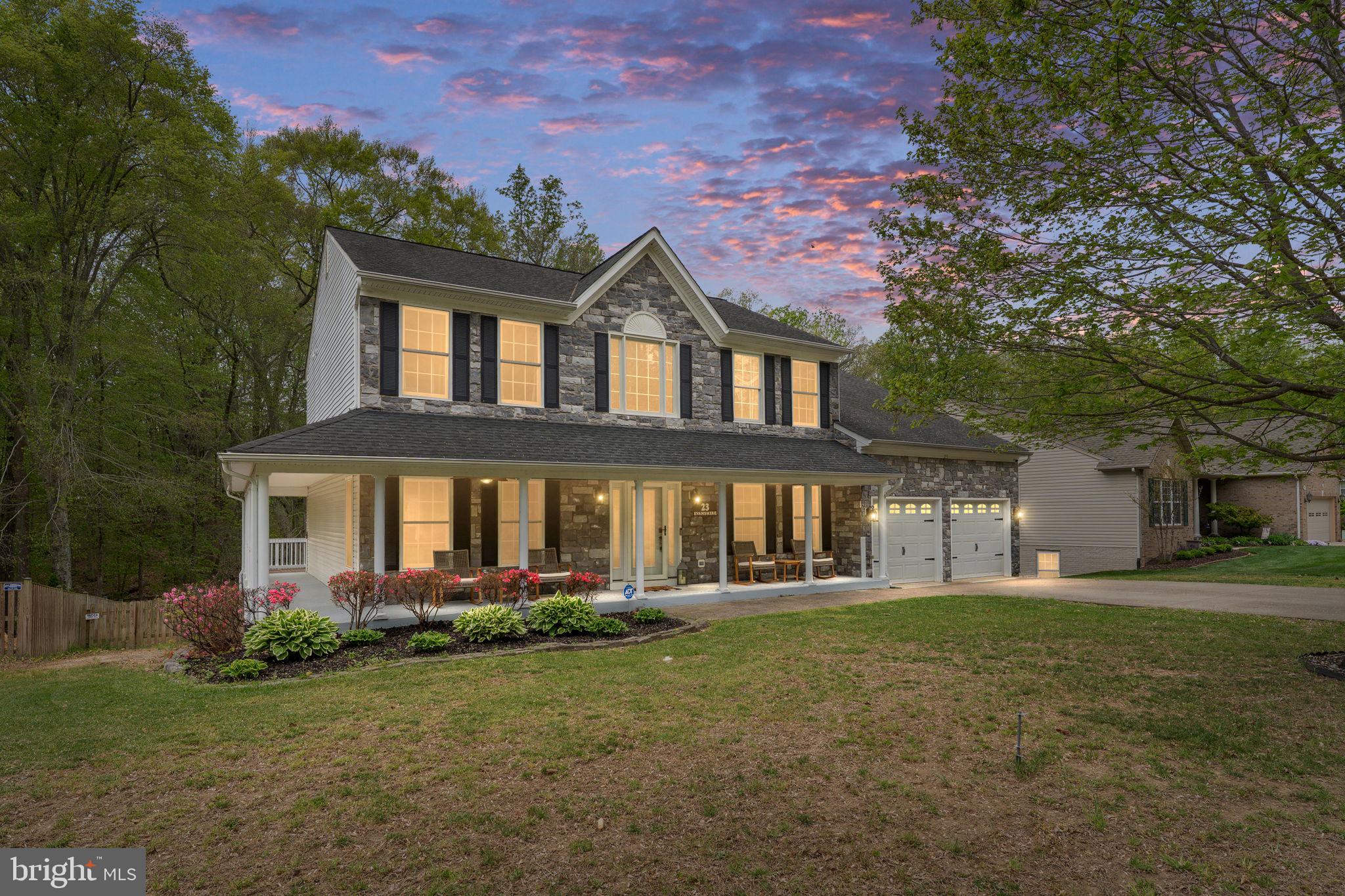 Potential assumable VA loan opportunity for qualified buyers with a 5.5% interest rate. 

Tucked away on a quiet cul-de-sac in the sought-after Cardinal Forest community, this expansive stone-front home offers the perfect blend of space, comfort, and convenience just minutes to I-95, commuter lots, the VRE, shopping, dining, and only a short drive to historic downtown Fredericksburg.

With over 4,700 square feet across three fully finished levels, this 5-bedroom, 3.5-bath home is designed for both everyday living and entertaining. A welcoming covered front porch that partially wraps around the home sets the tone, while inside you’re greeted by soaring two-story ceilings, 9+ foot ceilings, hardwood flooring, and an abundance of natural light.

The main level features a spacious layout with a sunroom bump-out, a family room with a wood-burning fireplace, and an upgraded kitchen complete with a center island, wall oven, and built-in cabinetry. The formal dining room showcases a bay window and leads into the generously sized sitting room, while a separate office with French doors provides a quiet, functional workspace. A bay-style door off the eat-in kitchen leads out to a massive deck overlooking a private, tree-lined and fenced in backyard, ideal for relaxing or hosting.

Upstairs, the primary suite offers a true retreat with a sitting area and sunroom bump-out, tray ceiling, and a large en-suite bath featuring a soaking tub, walk-in shower, dual vanities, and a custom walk-in closet with built-ins. Additional bedrooms are generously sized, and detailed finishes like crown molding, chair rail, and recessed lighting carry throughout the home.

The fully finished walk-out basement expands your living space even further with a full bedroom and bath, multiple living and recreation areas, plus a bar and second kitchen setup, perfect for guests, entertaining, or multi-generational living.

Situated on a beautifully landscaped lot backing to trees, this home also includes a 2-car attached garage and access to Cardinal Forest amenities including a pool, basketball courts, tennis courts, tot lots, and playgrounds.

A rare combination of size, location, and features, this home checks all the boxes.