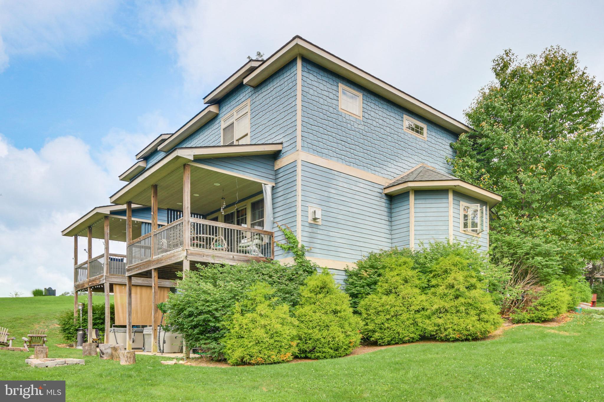 If being located in the heart of Deep Creek Lake is a must for you, this is your home. Offering three levels of living space, two master suites, hardwood flooring, granite counter tops, propane fireplace and an open floorplan. The outside space offers a great covered porch off of the main living area, and a nice lower level patio that boasts a hot tub and a firepit for your enjoyment. You can enjoy views of Wisp Ski Resort and beautiful lake views. This home won't last long, call today to preview.