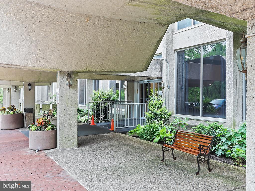 Welcome to this expansive 3-bedroom, 2.5-bath residence that has been transformed to a unique 2 bedroom with huge spacious rooms and exceptional fitted custom closets in the amenity-rich Green Hill community, set across 23 acres of beautifully landscaped Main Line grounds.
Step into this stunning 5th-floor “wrap unit,” offering approximately 1,910 square feet of thoughtfully designed living space, with natural light pouring in from three exposures. The well-appointed eat-in kitchen features updated appliances (the refrigerator and wall oven are new) and an enclosed utility room with a full-size washer and dryer, along with a recently upgraded electrical panel compliant with Lower Merion Township codes. Just off the entry, is a conveniently located powder room.
The dining area flows seamlessly from the kitchen and opens to the first of two private balconies—perfect for enjoying your morning coffee in the sunlight. The adjoining living room is impressively spacious, creating an inviting and comfortable setting for both relaxing and entertaining.
Down the hallway, the generously sized guest suite offers abundant closet space, built-in storage, and a private ensuite bath. Continue down the hallway to the true standout feature of this home: a combined second and third bedroom that creates a remarkably large primary suite enhanced with the second balcony, offering another outdoor retreat. This versatile space easily accommodates the bedroom plus a den or office or fitness area—tailor it to fit your lifestyle.  With more closet and storage space than you can imagine and a nearby full bath, this unique layout delivers flexibility rarely found in condominium living.

Additional highlights include a deeded indoor parking space ($170/month fee) in the East Garage, a storage space in the building’s lower level, and significant in unit closets.
Residents of Green Hill enjoy exceptional amenities, including 24/7 door staff, a staffed security gate, tennis and pickle ball courts , a modern playground, EV charging stations (fee based), a community based garden (modest fee and first come, first served basis) and access to both an outdoor seasonal pool and an indoor heated pool and fitness center (modest fees apply). The monthly HOA fee conveniently covers all utilities except cable and internet. Located within the award-winning Lower Merion School District, this home also offers easy access to Center City by car or train, along with the best shopping, dining, and conveniences of the Main Line and City Avenue corridor.
A rare opportunity offering space, light, flexibility, and value—this could be the place you’ll love to call home.