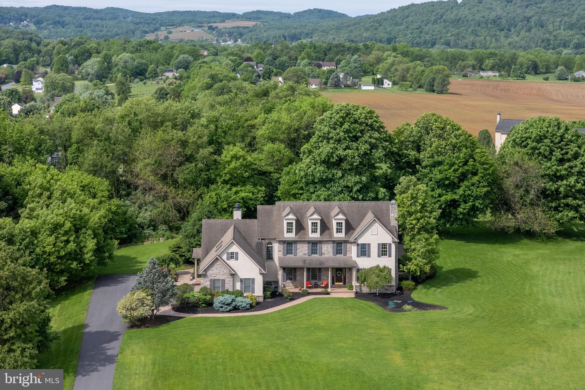 Discover RESORT-STYLE LIVING in the highly sought-after Woodside Estates of Williams Township. Perfectly positioned on 1.82 ACRES, this beautiful 5 bedroom, 4.5 bath CUSTOM home offers over 4400 square feet of thoughtfully designed living space and a BACKYARD RETREAT ready to enjoy this summer. Step right into the foyer where a formal dining room and COZY living room with GAS fireplace welcome your guests. The beautifully appointed kitchen with RICH, DARK WOOD custom ceiling-height cabinetry, upgraded appliances, and GRANITE countertops opens to the large family room which offers an abundance of NATURAL LIGHT, GAS STONE fireplace and views of the backyard pool. A FIRST FLOOR BEDROOM with full bathroom gives privacy for guests or can be used as a home office/den. The main staircase with a large picture window and bench seat in the landing area leads you up to the large PRIMARY suite with separate sitting room, 2 walk-in closets, and en suite bath with RADIANT HEATED flooring and jacuzzi tub. Three additional bedrooms and 2 bathrooms complete the 2nd level. The unfinished basement with Bilco door offers plenty of extra storage space along with the 3 car garage. The RESORT-LIKE BACKYARD with in-ground GUNITE HEATED pool with spa, rock waterfall, LUSH landscaping, and ample patio space is the perfect spot for RELAXING and hosting unforgettable summer gatherings. This ELEVATED setting enhances the PEACEFUL atmosphere and scenic surroundings of both the Delaware River and New Jersey in the distance making this property not only conveniently located, but a rare RETREAT in one of Williams Townships most desirable neighborhoods.