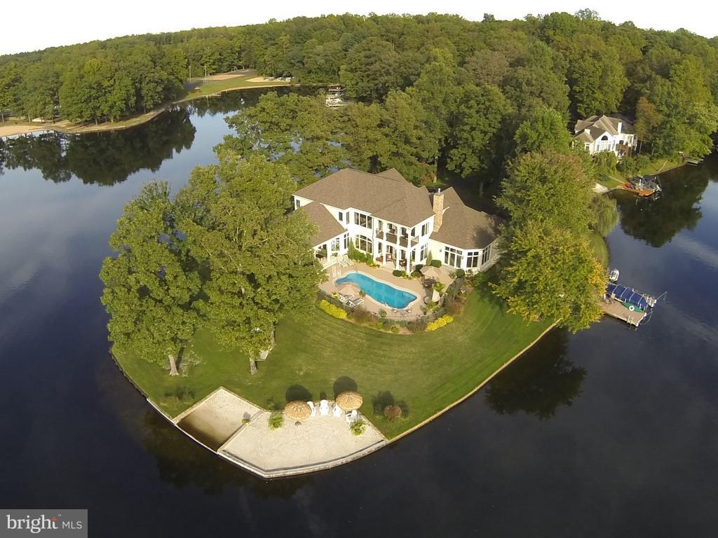 Boasting 700 ft of waterfrontage, spectacular sunsets & panoramic views. Riddle Construction's personal home is the closest you'll come to owning your own island in Lake of the Woods! 7900 sq ft under roof, 6000 finished living. 5 bedrooms, 5 baths, and 5 car garage (two tandem)  Exceptional in every aspect. You'll enjoy a private beach, pool, theatre room, whole house sound system & much more.
