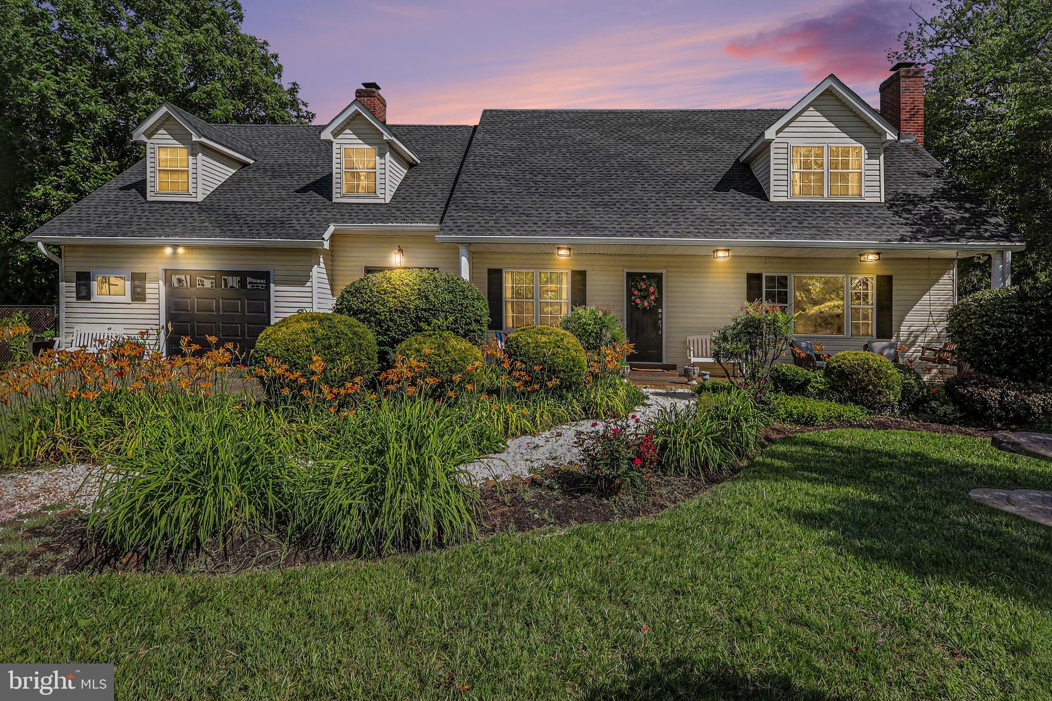 If you're looking for space, privacy, and versatility, look no further than this beautifully maintained home nestled on nearly 3 landscaped acres. 

With nearly 4,000 square feet of finished living space and an additional 1,700 square feet in the unfinished walkout basement, there is room for everyone, plus ample space for a workshop, hobbies, or future expansion. This exceptional property also features a private apartment with an additional 960 square feet of living space, including its own separate entrance, offering incredible flexibility for multi-generational living, extended family, guests, a home office, or potential rental income.

The home offers 5 bedrooms and 4 bathrooms, all featuring recently updated tiled showers or tubs. The main level includes a guest bedroom, spacious living room, formal dining room, eat-in kitchen, cozy family room, and convenient main-level laundry. Two wood-burning fireplaces and beautiful oak flooring add warmth and timeless character throughout.

The expansive primary suite features a private sitting room and an en-suite bath complete with a soaking tub and separate shower, creating the perfect retreat.

Recent improvements include a newer roof with thermostat-controlled attic fans, oversized gutters, and gutter guards. The upgraded 400-amp electrical service supports a recently installed whole-house generator, providing peace of mind in any weather. A spacious three-car garage, built in 2021, offers abundant room for vehicles, equipment, and storage. A separate 12' x 20' storage shed provides additional space for gardening tools, hobbies, or outdoor equipment.

Outside, the meticulously landscaped grounds are filled with flowering trees, shrubs, and heirloom flowers. Enjoy apple and pear trees, flowering dogwoods, cherry trees, crape myrtles, and roses that provide color and beauty throughout the seasons.

Conveniently located just 12 minutes from Main Street in Old Town and only 10 minutes from shopping and schools, this property offers the perfect balance of peaceful country living and everyday convenience. With no HOA, you'll have the freedom to bring your goats and chickens, park your RV, host gatherings, or enjoy the privacy and natural beauty that surrounds you.

Escape the ordinary and discover this charming country oasis.