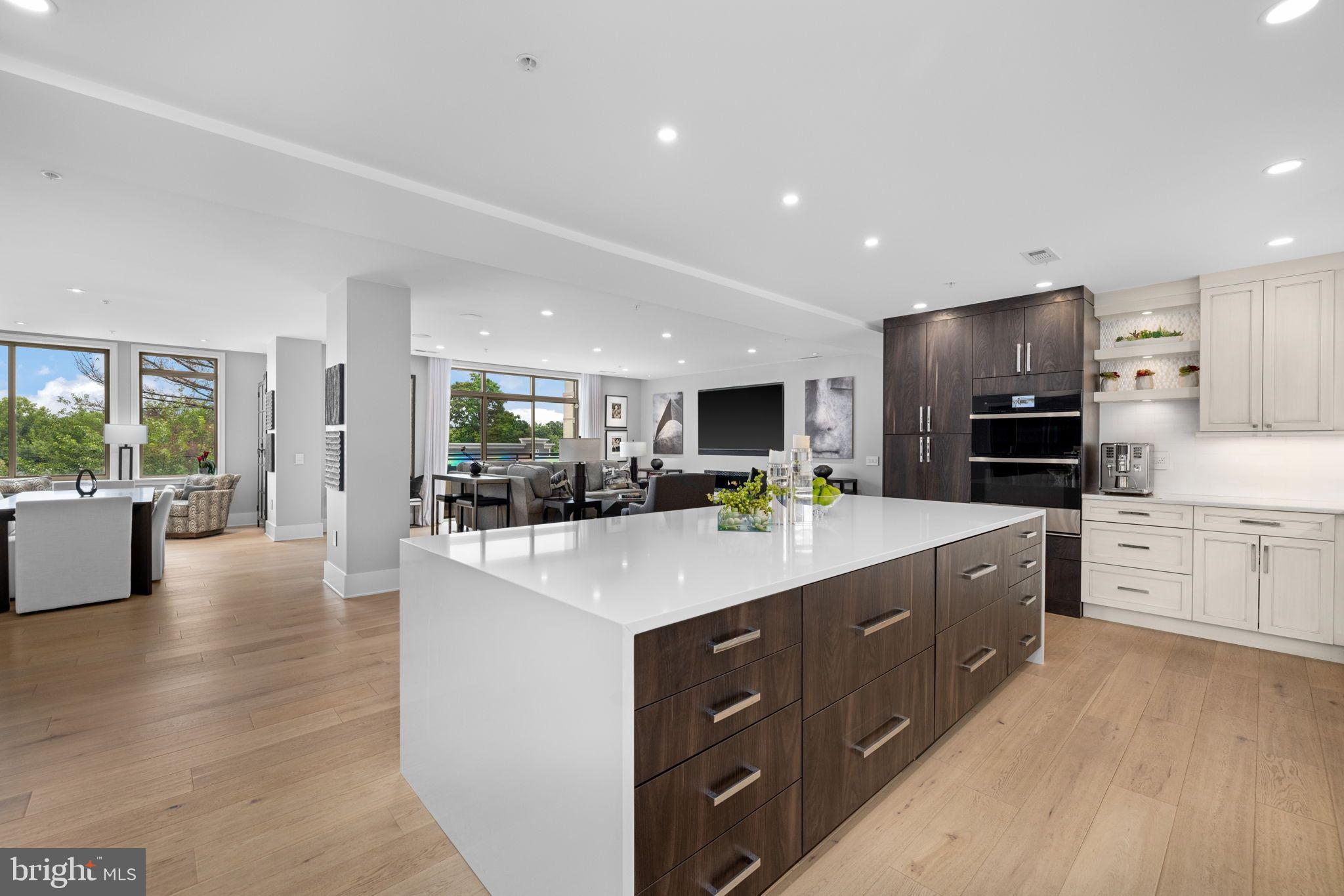 Beautifully renovated two-bedroom condo at the sought-after Palladium in McLean! This residence has been completely remodeled with an open layout, added ceiling height, gorgeous wide-planked hardwood floors, automated window treatments, and versatile spaces. From the foyer, the open concept layout offers a large living room with a fireplace, a custom wall space that accommodates a 98" television and access to one of two private balconies. The living room is open to both the spacious dining room and the expansive gourmet kitchen. With quartz counters, capacious cabinetry and shelving, an expansive center island with a waterfall edge, generous storage and refrigerator and freezer drawers for added convenience, and top-tier appliances that include a professional Thermador cooktop with six burners and a grill, this kitchen is a chef's dream.

The primary suite is a luxurious retreat with a large bedroom, a sitting room that makes an ideal office or reading area, a second private balcony, dual walk-in closets and a spa-like primary bath that features dual vanities, a seamless glass shower and abundant storage. A well-appointed second bedroom suite, a powder room and a laundry room with a high-efficiency stacked washer and dryer complete this condo. Located just steps from the elevator, it's easy to access the two assigned parking spaces and the large storage room that convey.

The Palladium amenities include a staffed front desk, a gym, a library and party room, as well as outdoor spaces that include a courtyard and a large plaza with a fountain. Walkable to all of the shops, restaurants and grocery stores McLean has to offer, this central location is also ideal for easy commuting to Tysons, Reston, Arlington and Washington, DC with its close proximity to many commuter routes.