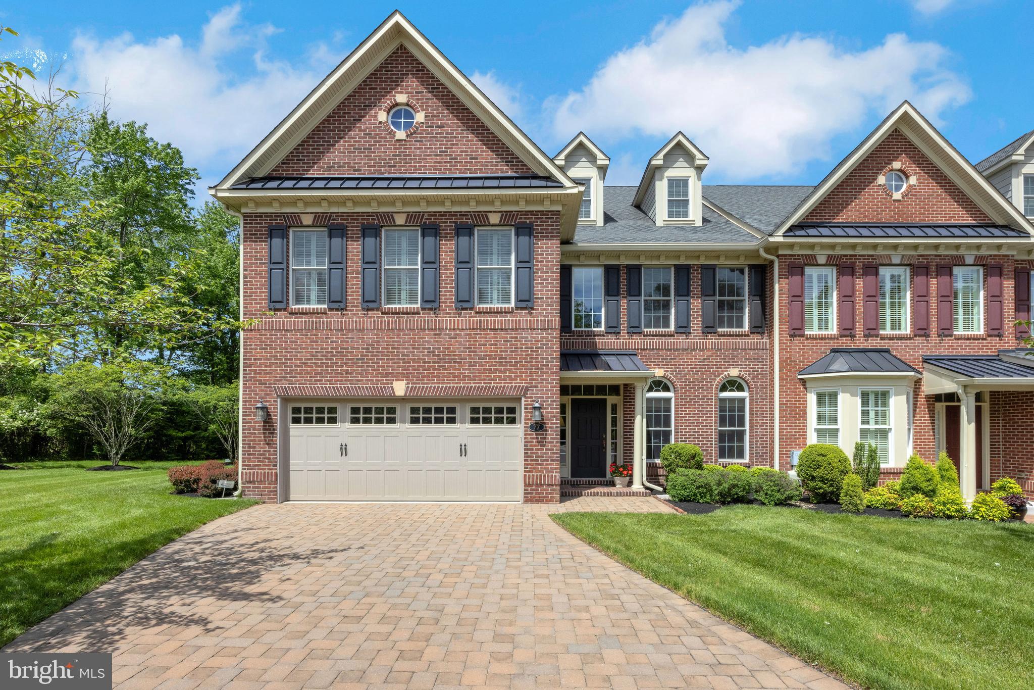 Elegant Townhome in Premier 55+ Community with Wooded Views & Elevator Access. Nestled in the sought-after Delancey Court 55+ community, just minutes from the heart of historic Newtown Borough, this meticulously appointed townhome offers the perfect blend of privacy, luxury, and low-maintenance living. Perfectly positioned within the neighborhood on a premium lot backing to serene woods, this residence welcomes you with a paver driveway, covered portico, and manicured landscaping that hints at the elegance within. Step inside to discover a bright and open floor plan, enriched by abundant natural light, hardwood flooring throughout the main level, and high-end designer touches. A grand open staircase and a spacious private elevator ensure easy accessibility to all three levels of the home. At the heart of the main floor is a stunning gourmet kitchen with rich cherry cabinetry, a peninsula for added prep space, granite countertops, a decorative tile backsplash, and premium stainless-steel appliances including a gas cooktop with hood. The kitchen flows seamlessly into a sunny breakfast area and expansive great room, where soaring two-story windows frame tranquil wooded views and a cozy fireplace anchors the living space. Step outside to a private composite deck, perfect for relaxing or entertaining amidst lush landscaping and peaceful surroundings. Upstairs, the primary suite is a luxurious retreat featuring dual walk-in closets with custom organizers and a spa-like bath complete with a soaking tub, oversized shower, dual vanity, and separate water closet. Two additional bedrooms and a hall bath — one with direct access — offer ample space for guests. A versatile loft overlooks both the family and living rooms, while a finished third-floor bonus room provides endless flexibility for an office, den, or extra guest suite. Additional highlights include a stylish powder room, oversized 2-car garage, full security system, and extensive upgrades throughout. Residents of Delancey Court enjoy access to a spectacular 5,076 sq. ft. clubhouse featuring an indoor pool, state-of-the-art fitness center, billiards and card rooms, library, social lounge, and outdoor pool with a covered patio, garden area, grilling station, and bocce court. Conveniently located near shopping, dining, Tyler State Park, Washington Crossing, and major routes for easy access to Philadelphia, Princeton, and New York City, this exceptional home is the epitome of luxury and lifestyle in a vibrant 55+ community.