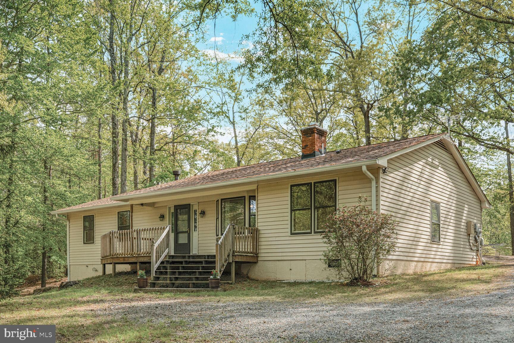 Enjoy peace and tranquility with country living on massive treed approximate 5.80 acre lot, yet within easy commute to stores and restaurants.  Easy one-level living with ceiling fans galore, updated kitchen with stainless appliances, induction cooktop, 42" cabinets, built-in microwave and wall oven, remodeled baths, and Energy Star front door circa 2022.  Tons of parking.  Leonard shed with workshop, small barn with lawn mower storage.  3 bedrooms, office adjacent to kitchen, and family room with full bath off dining room.