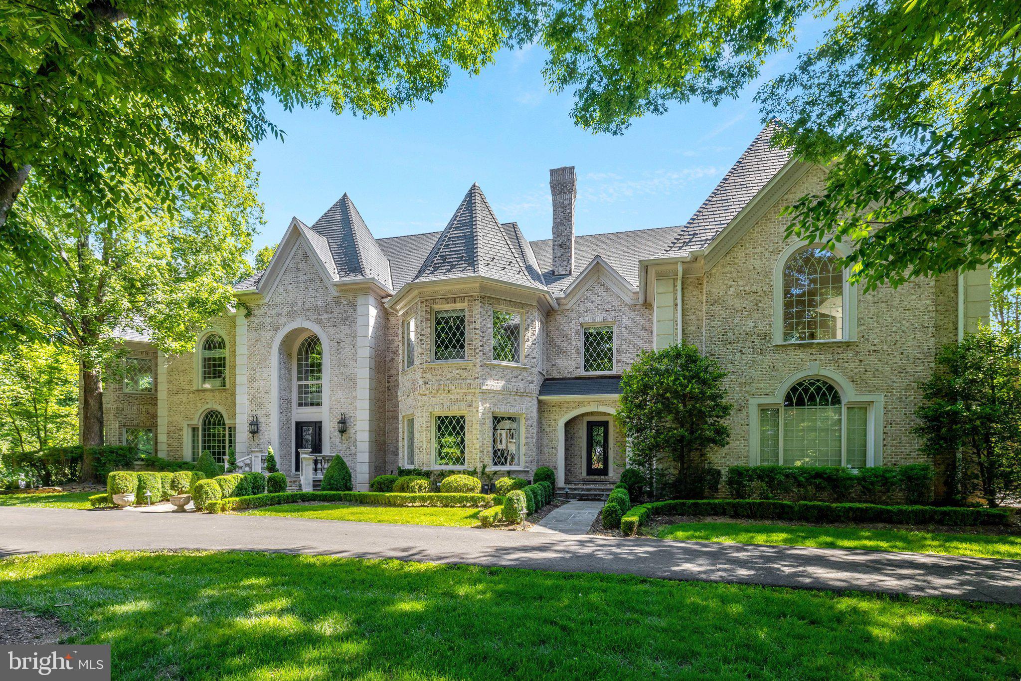 Country chateau in highly desirable Falcon Ridge neighborhood. Mansion-quality and built with exceptional structural integrity, including all steel reinforcements. A custom brick exterior with concrete stone quoins and arched precast window surrounds and thresholds add intrigue and appeal; while interior archways, Adams moldings, tray, cathedral, coffered ceilings and updated hardwoods are gracefully incorporated throughout. Imported Italian and French marble floors, 21 ft. ceilings and French plaster ornamental moldings accentuate the twin-staircase circular foyer while barrel vaulted doorways light-up at dusk to guide friends and guests throughout the formal living, music and banquet-sized dining room. An equally impressive great room features a built-in media center with 22 ft., Italian stone raised-hearth fireplace and an incredible wall of windows that overlook the outdoor paver terrace, magnificent fireplace, covered pergola and ornamental fountain. Relax and unwind in the 12 ft. coffered-ceiling mahogany library or light-filled Garden Room that has vineyard-style wrought-iron gates and a raised hearth dual-sided fireplace that is shared with the Library.
 A stunning gourmet kitchen has custom white cabinets and oversized mitered quartz island, multiple cooking stations including a 60 inch wolf range, Italian stone travertine (12” x 24”) floors, custom quartz backsplash and a butler’s pantry. Adjacent breakfast room that is open to the lounge overlook above has a warm and inviting Pennsylvania fieldstone fireplace and three-story windows. 
The upper level quarters have an array of bedroom suites with updated bathrooms and walk-in closets. The owner’s domain provides numerous amenities that include: a well-appointed morning kitchen, Corinthian column sitting room with sumptuous French marble fireplace, mirrored dressing hall and two walk-in closets. The spa-inspired owner’s bath has 18” x 18” silver travertine stone floors, white-gray quartz counters, and an ultra-luxurious shower enclosure with freestanding soaking tub. The fourth level has a bedroom with suite with an updated shared full bath, casual living room, gym, and loft area. 
A walk-out lower level is the ideal entertainer’s playground with a custom Mahogany (500-bottle) wine cellar with wrought-iron vineyard gates, adjacent wet bar, media room with platform seats, billiard area, casual living room, and bedroom suite with shared full bath. Lastly there is over 2,000 sq. ft. of storage space in the lower level. 
Enjoy the many terraces, decks and gardens along with the covered outdooring living room with stone fireplace and built-in grilling station allow for exciting entertaining well into the evening and is the perfect backdrop for outdoor living.