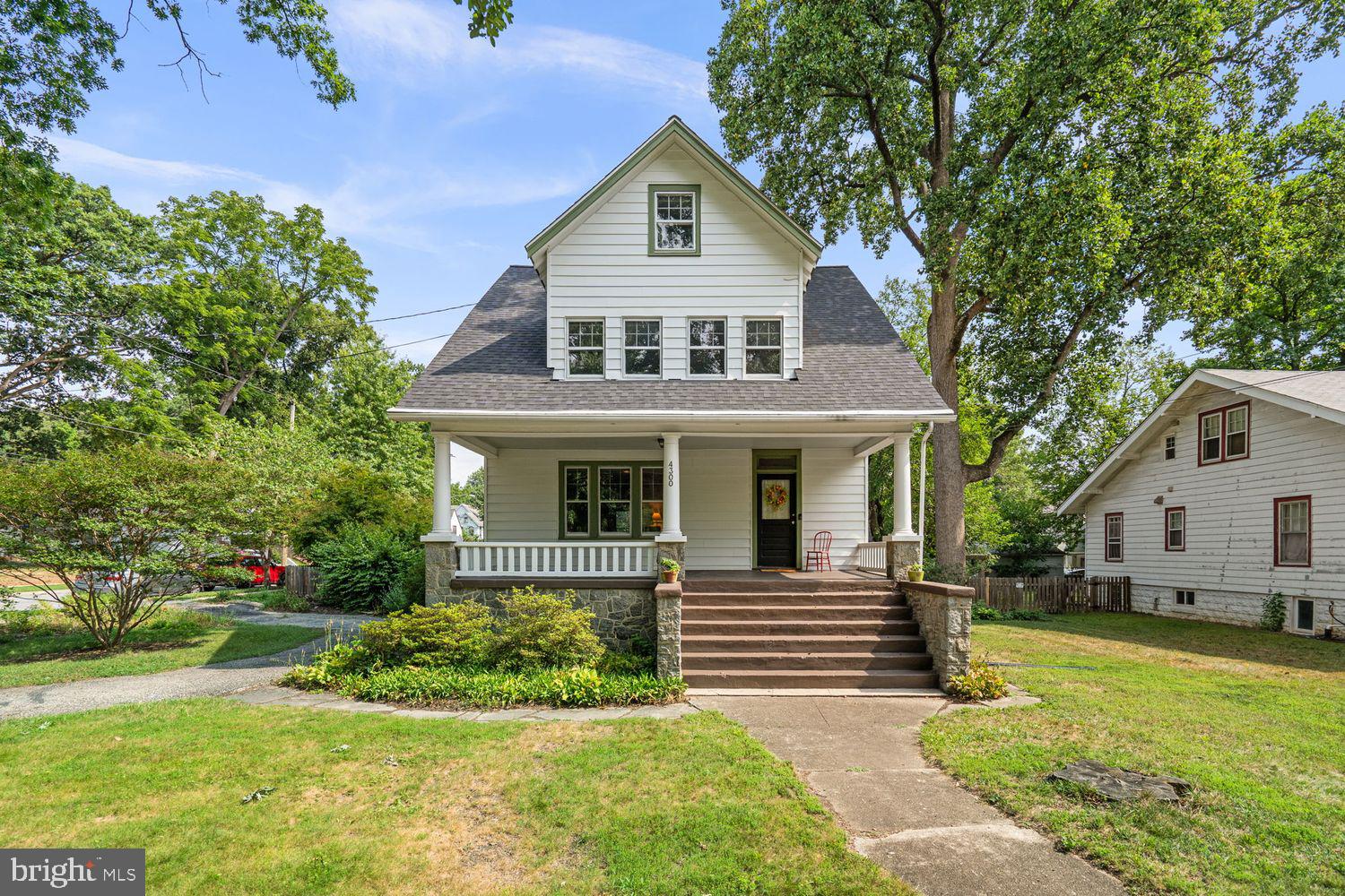 Welcome to 4300 Queensbury Road, a beautifully preserved 1916 Craftsman bungalow offering 4 bedrooms, 2.5 baths, and timeless architectural character on a picturesque corner lot in the heart of historic Hyattsville. Rich in original craftsmanship and thoughtfully maintained over the years, this exceptional home features generous living spaces, off-street parking, and a beautifully landscaped backyard, all in one of the area’s most walkable and beloved neighborhoods. A welcoming front porch sets the tone before stepping inside, where original fir flooring on the main level paired with five-panel wood doors, rich trim, built-in bookcases, a brick fireplace, and a classic staircase, reflect the home’s enduring craftsmanship. Unlike many renovated properties, this residence retains its traditional floor plan, preserving the warmth, charm, and architectural integrity that define a true Craftsman.

The gracious living room flows naturally into a generously sized dining room before opening to a spacious family room at the rear of the home. Filled with natural light, this flexible gathering space offers direct access to the rear deck and expansive, fully fenced backyard, creating a seamless connection between indoor and outdoor living. Beautifully landscaped gardens surround the home, offering the perfect setting for entertaining, gardening, or simply enjoying the outdoors. The kitchen is a functional and practical space, offering ample cabinetry, laminate countertops, and a mix of appliances including a stainless steel refrigerator. A full bath conveniently located off the family room completes the main level.

Upstairs, three spacious bedrooms feature multiple exposures, large windows, pine floors, and generous closet space, including walk-in closets. A timeless hall bath serves this level, while the finished third-floor attic provides exceptional flexibility as a fourth bedroom, home office, playroom, or recreation space. An additional half bath on this level presents an opportunity for future conversion to a full bath. The unfinished lower level provides extensive storage and outstanding potential for future expansion. Recent improvements include a new roof, along with updates to the heat pump and air conditioning systems. Ideally located, 4300 Queensbury Road is just a short walk to the Riverdale Park MARC Station, Metro access, and neighborhood parks. Local favorites including 2Fifty Texas BBQ, Manifest Bread, Busboys and Poets, Franklin’s, Pizzeria Paradiso, Shagga Coffee, and the renowned Riverdale Park Farmers Market, along with Whole Foods at Riverdale Park Station, are all nearby, offering a unique blend of small-town charm and urban convenience.