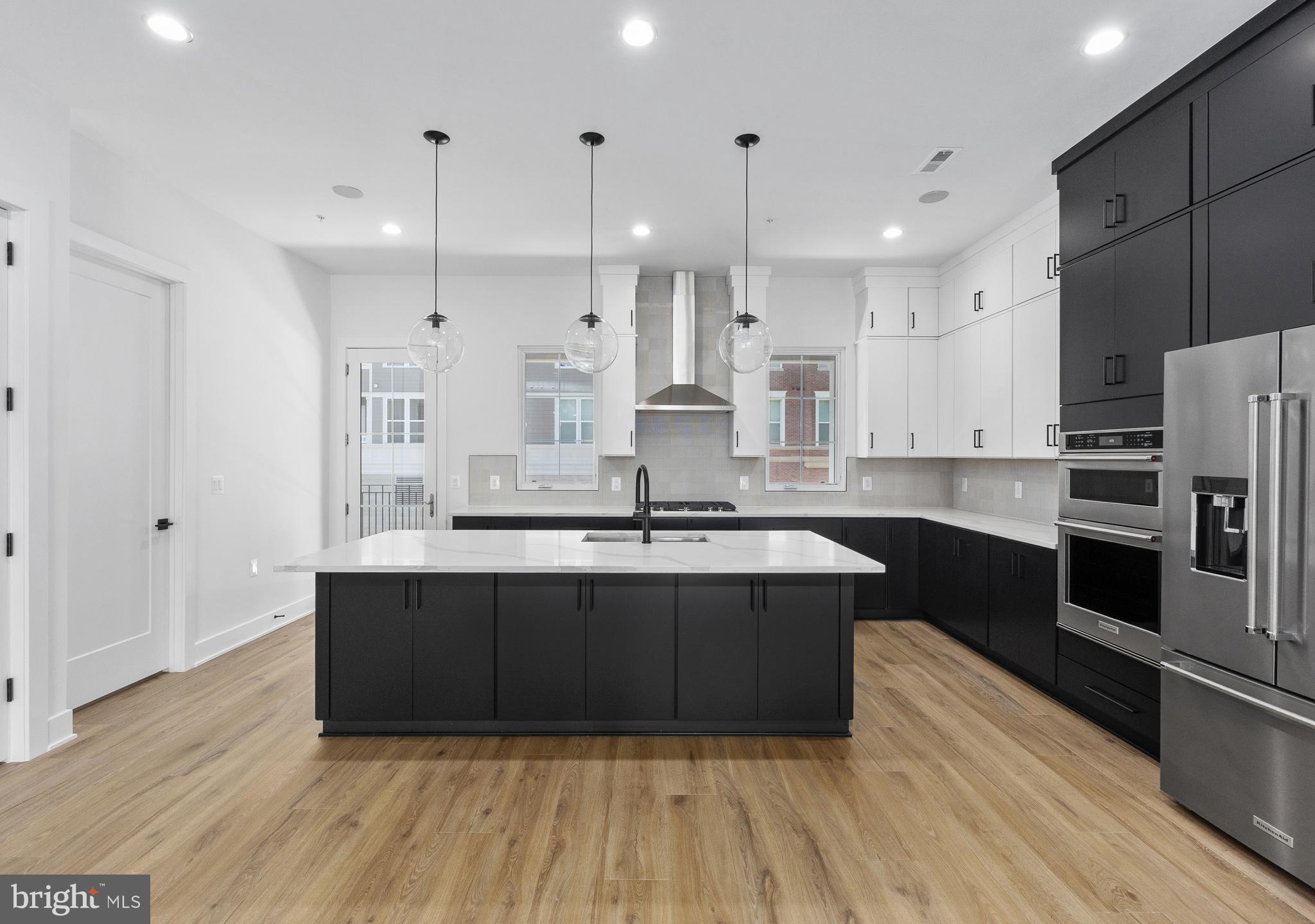 This exceptional luxury townhome, complete with a private home elevator, is a true masterpiece that blends thoughtful design with high-end finishes throughout. The first-floor flex room, paired with a convenient powder room, offers versatile space perfect for a spacious home office, a dedicated workout room, or both. The second floor boasts an expansive, open layout designed for effortless entertaining, featuring a chef-inspired kitchen, a spacious dining room, and a generously sized great room. A walk-in pantry and access to a covered deck enhance the kitchen’s functionality, while the great room's charming Juliet door adds a touch of elegance. The third floor is home to the luxurious primary bedroom suite, complete with ample closet space, alongside two additional bedrooms and a stylish full bath with a double vanity. Take the private elevator up to the rooftop terrace, where you can unwind by the fireplace on cool evenings or bask in the sunshine beneath the retractable awning. Conveniently located within walking distance of Chevy Chase Lakes retail center, and just a short drive from the vibrant shopping, dining, and entertainment options in Chevy Chase Circle, Friendship Heights, and Washington, D.C., this home offers the perfect blend of luxury, comfort, and modern living.