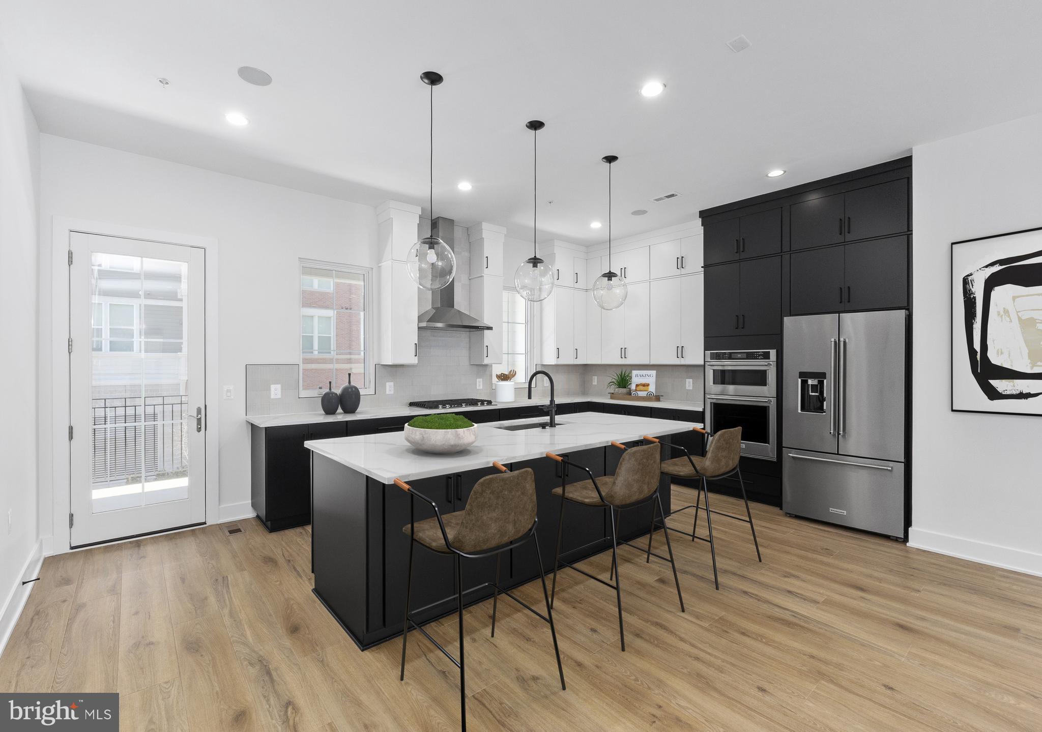This exceptional luxury townhome, complete with a private home elevator, is a true masterpiece that blends thoughtful design with high-end finishes throughout. The first-floor flex room, paired with a convenient powder room, offers versatile space perfect for a spacious home office, a dedicated workout room, or both. The second floor boasts an expansive, open layout designed for effortless entertaining, featuring a chef-inspired kitchen, a spacious dining room, and a generously sized great room. A walk-in pantry and access to a covered deck enhance the kitchen’s functionality, while the great room's charming Juliet door adds a touch of elegance. The third floor is home to the luxurious primary bedroom suite, complete with ample closet space, alongside two additional bedrooms and a stylish full bath with a double vanity. Take the private elevator up to the rooftop terrace, where you can unwind by the fireplace on cool evenings or bask in the sunshine beneath the retractable awning. Conveniently located within walking distance of Chevy Chase Lakes retail center, and just a short drive from the vibrant shopping, dining, and entertainment options in Chevy Chase Circle, Friendship Heights, and Washington, D.C., this home offers the perfect blend of luxury, comfort, and modern living.