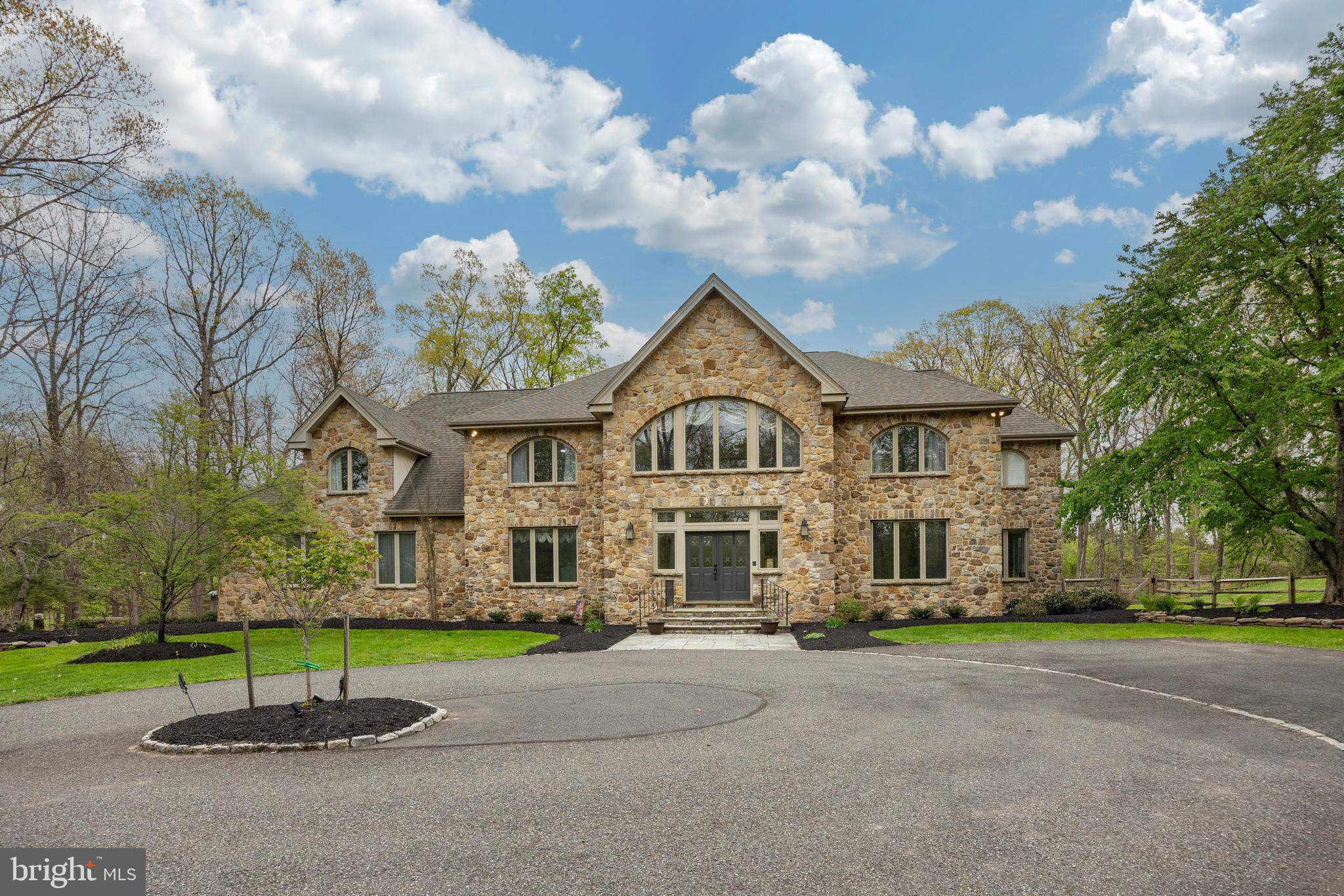 Looking for a tranquil, peaceful setting?  Come take a look at this gorgeous estate home. 6,497 Sq. Ft. Surrounded by 4+ acres, you'll be in your own little world. The double doors lead you to an amazing 2 story foyer. The newer chandelier sparkles & sconce lighting adds to the ambiance. Hardwood floors with perimeter inlay flow through the foyer, dining and living room. Celebrate the holidays in your new formal dining room with butlers pantry. The living room is quite large and could easily accommodate your baby grand piano or create a separate cozy seating area. Need a dedicated home office, with custom built ins for storage? And French doors? Movie nights in the step down family room.  Light the gas fireplace on the chilly nights and snuggle down. The gourmet kitchen and breakfast room is right around the corner. The chef will be quite happy. 5 burner cooktop, Kitchen Aid double ovens and microwave. Custom wall to wall cabinet space for all your kitchen gadgets and platters. Check out the pantry, too! Friends and family can relax at the table or 8' kitchen island. Ample counter and prep space. Beautiful glass tile backsplash with uner cabinet lighting. The sink area opens to the solarium allowing for easy conversation! The 2 story solarium with a wall of windows (some with built in blinds) is spectacular! The newer, covered deck,  adjoins the solarium with French doors. There's about 650 square feet of outdoor entertaining area plus the patio. The recent expansion of the fenced in back yard allows for more space for our furry friends or little ones.  Luxury awaits as you ascend the curved staircase to the impressive landing. Palladium windows and the chandelier make a very impressive showing. The primary bedroom offers 2 walk in closets. The ensuite custom bathroom  is right out of a magazine. Heated tile flooring, separate tiled shower and a wall of cabinetry with 2 sinks give each of you plenty of elbow room. Even the hard days will melt away in this bathtub, situated under a beautiful bank of windows with plantation shutters. Bedroom 2 is a princess (or prince) suite with it's own bathroom. Bedroom 3 is quite large with recessed lighting. There are French doors which open to overlook the solarium below. Bedroom 4 & 5 are quite generous in size. Both with fans and crown molding. They share the updated hall bathroom. There's a great area at the top of the back staircase  providing some storage or even a small play/toy space for the little ones. Head down to the finished basement which does not seem like a basement at all. An additional 2,000+ sq. ft.! Daylight walk out with a window and double doors. A gas fireplace and a recently constructed THEATER! Theater seats, screen and projector included. And a round cushy chair to curl up in for movie night! There's a room for crafts and another for your gym equipment. Plus an updated powder room! Newer heating system and roof in the last few years. Central Vac & speaker system. Souderton Schools. Easy access to shopping and the PA Turnpike.